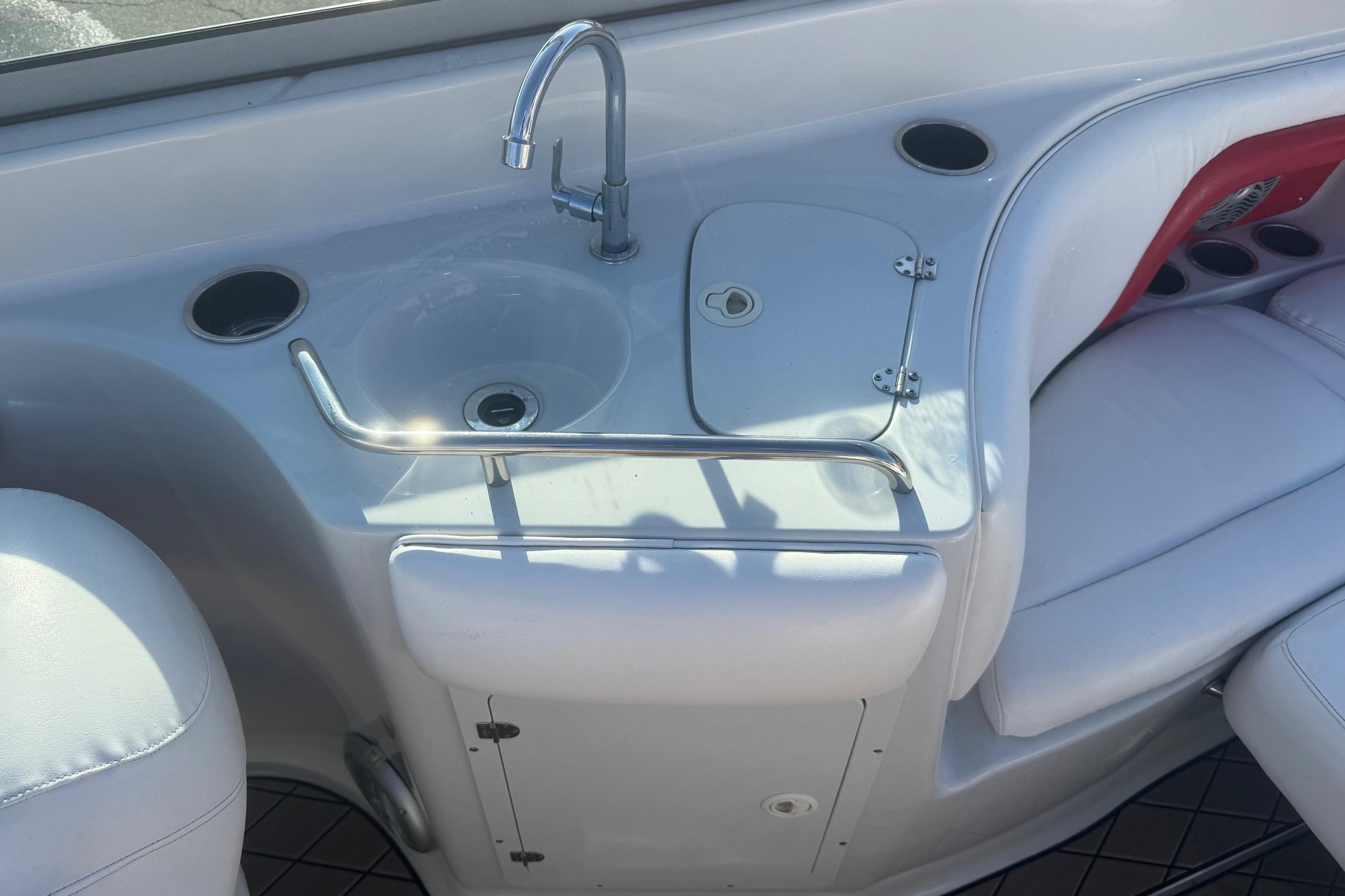 2005 Crownline 270 BR boat interior with sink and seating area.