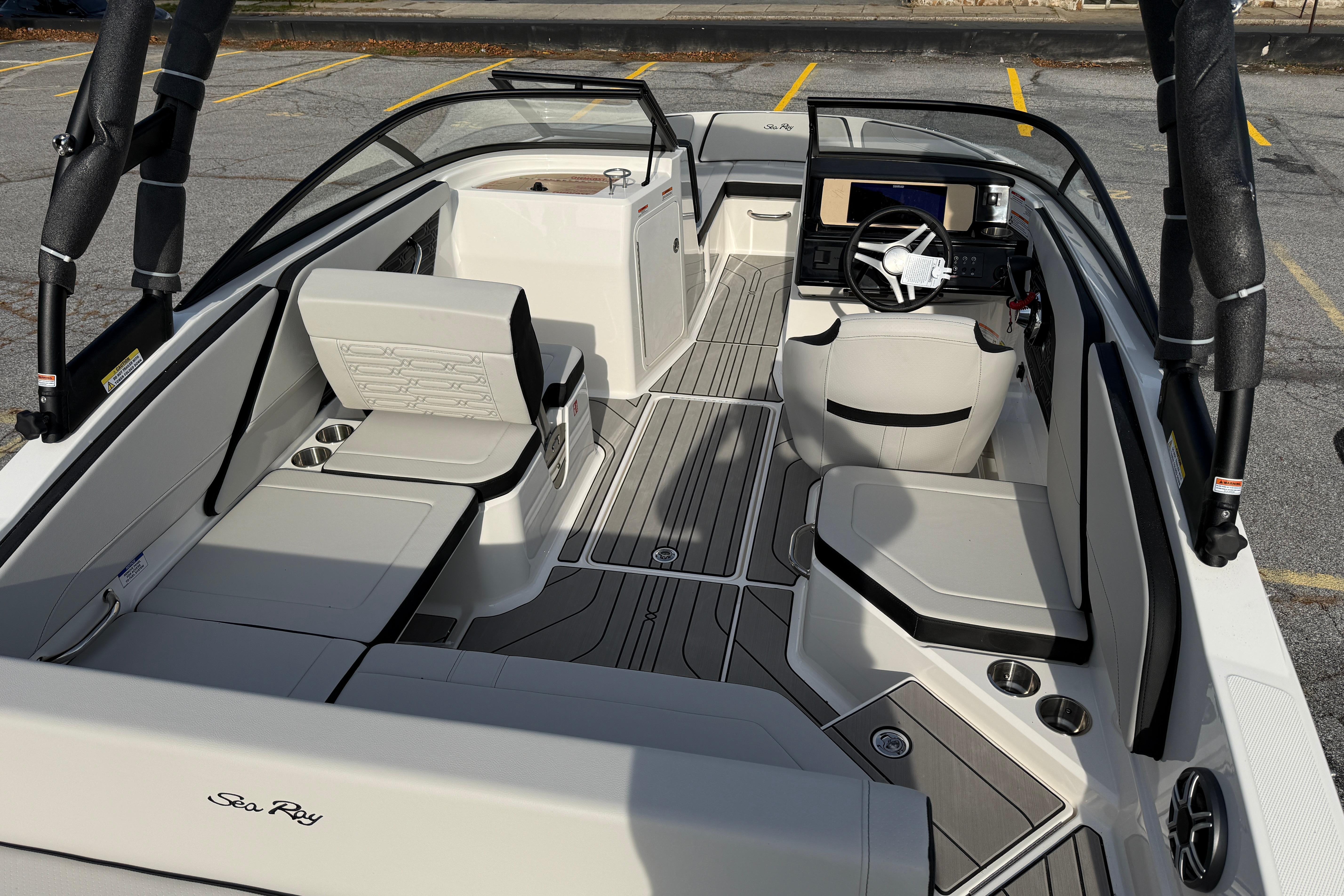 2026 Sea Ray SPX 210 Outboard boat interior with modern seating and steering console.