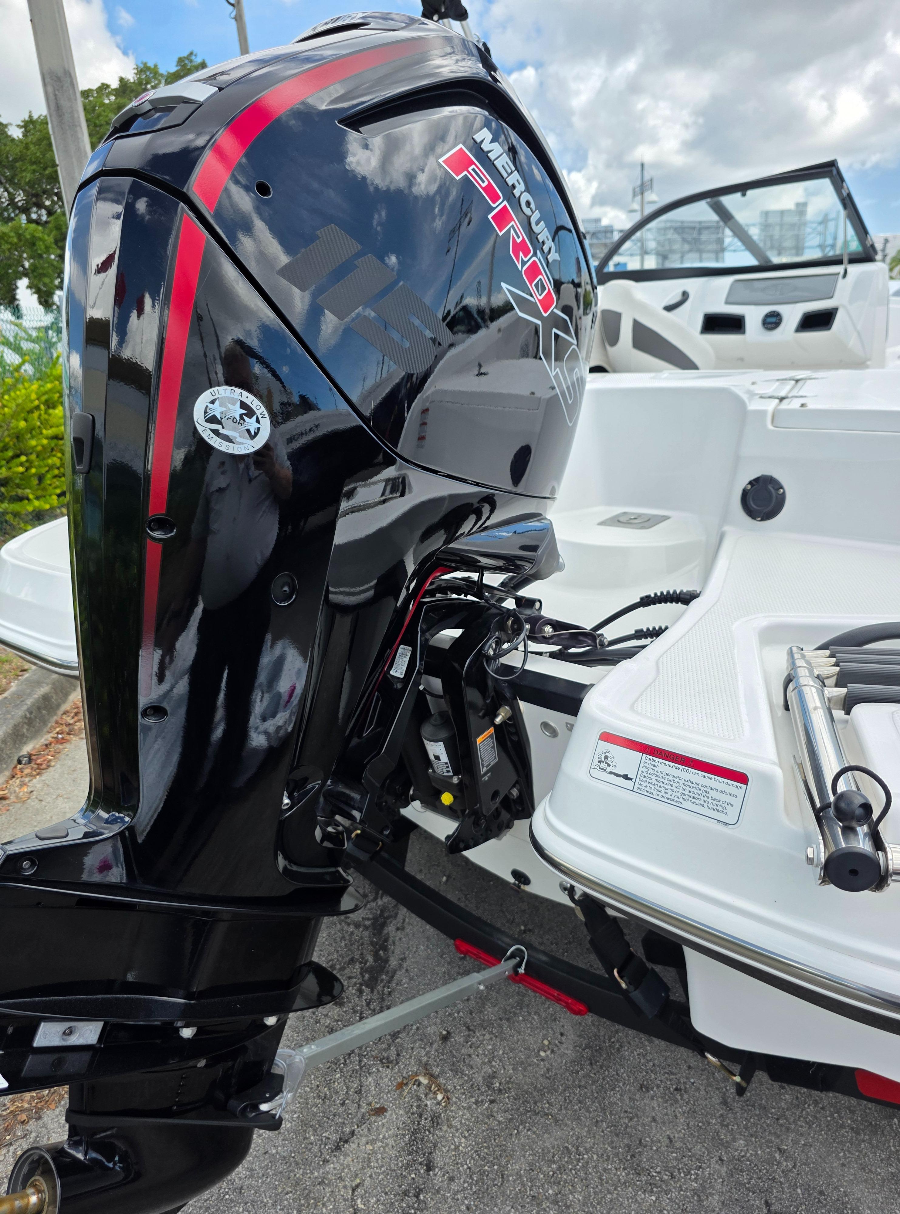 2024 Tahoe 185 S boat with Mercury Pro outboard motor, docked under a cloudy sky.