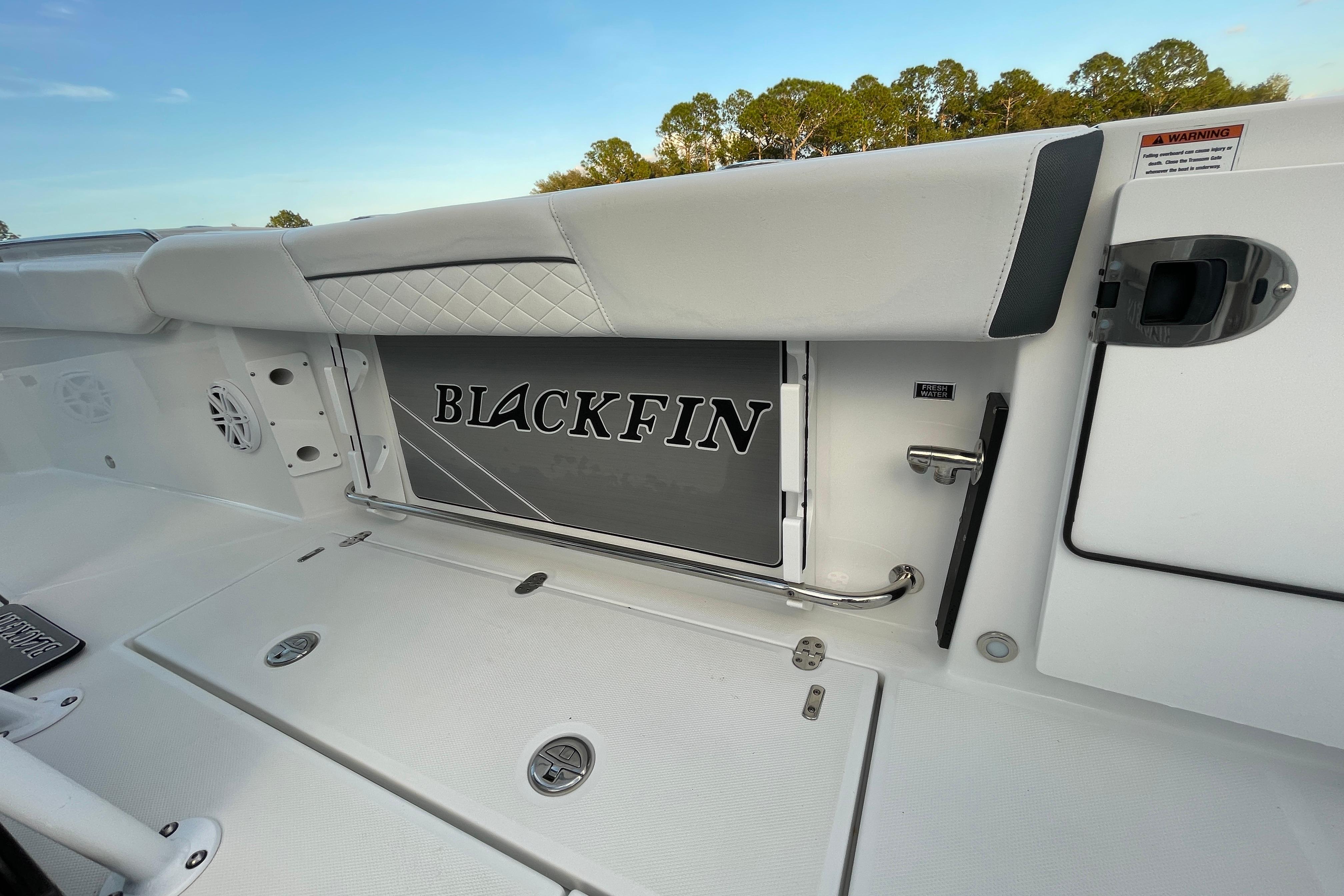 2022 Blackfin 252 CC boat interior with branded storage compartment and sleek design.