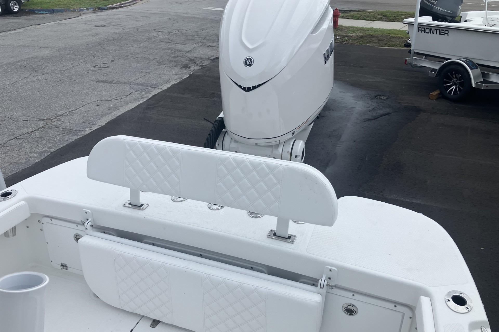 2026 BlackJack 256 Coastal boat with white seating and powerful outboard motor.