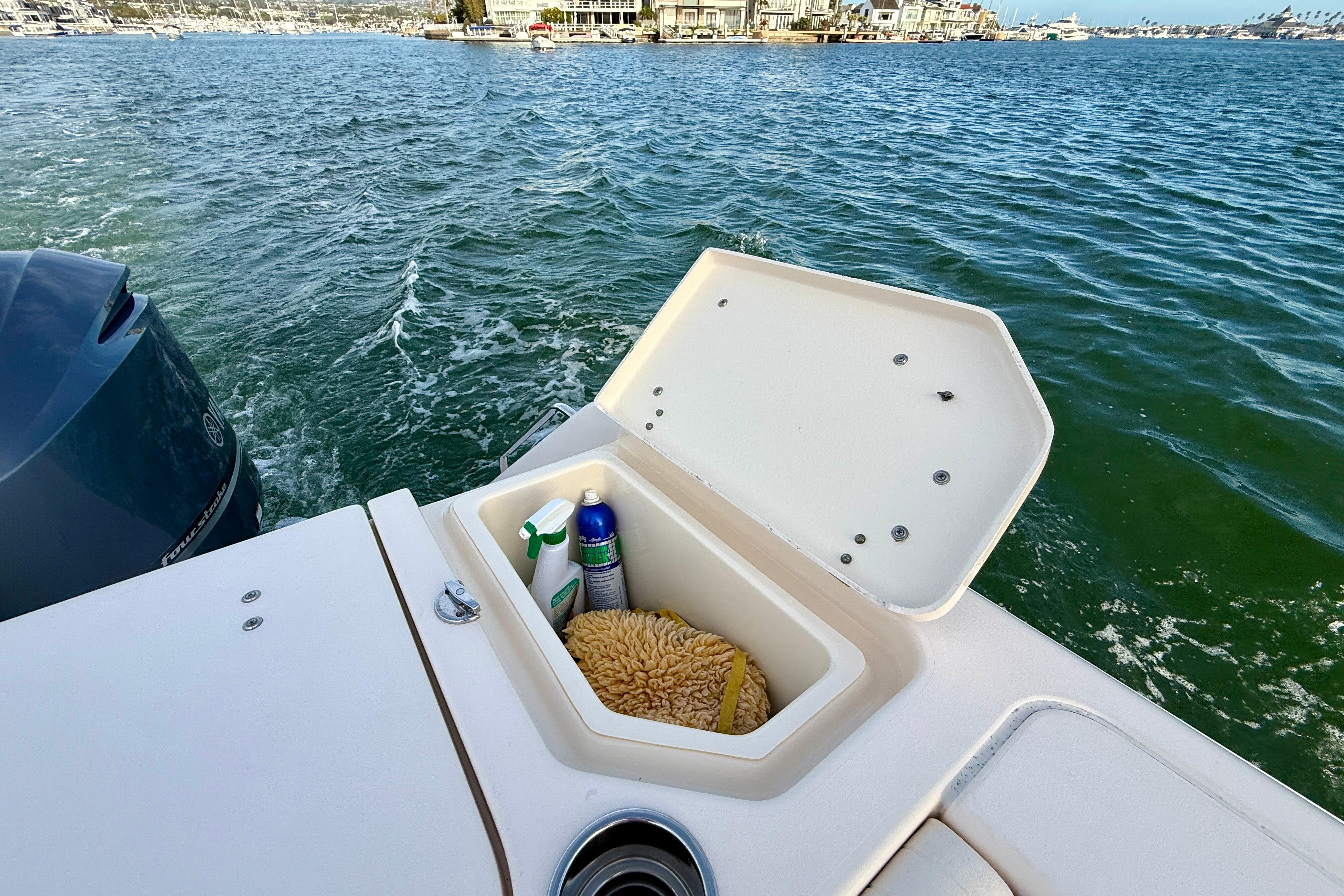 2012 Grady-White Canyon 336 boat with open storage compartment on the water.