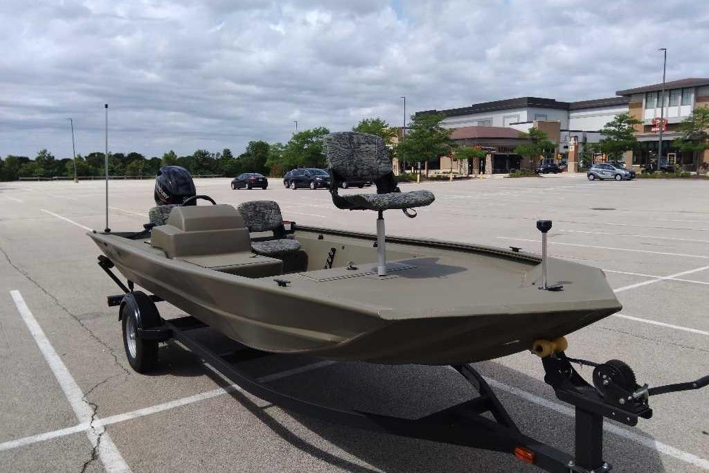 2026 Tracker Grizzly 1754 SC boat on trailer in parking lot, under cloudy sky.
