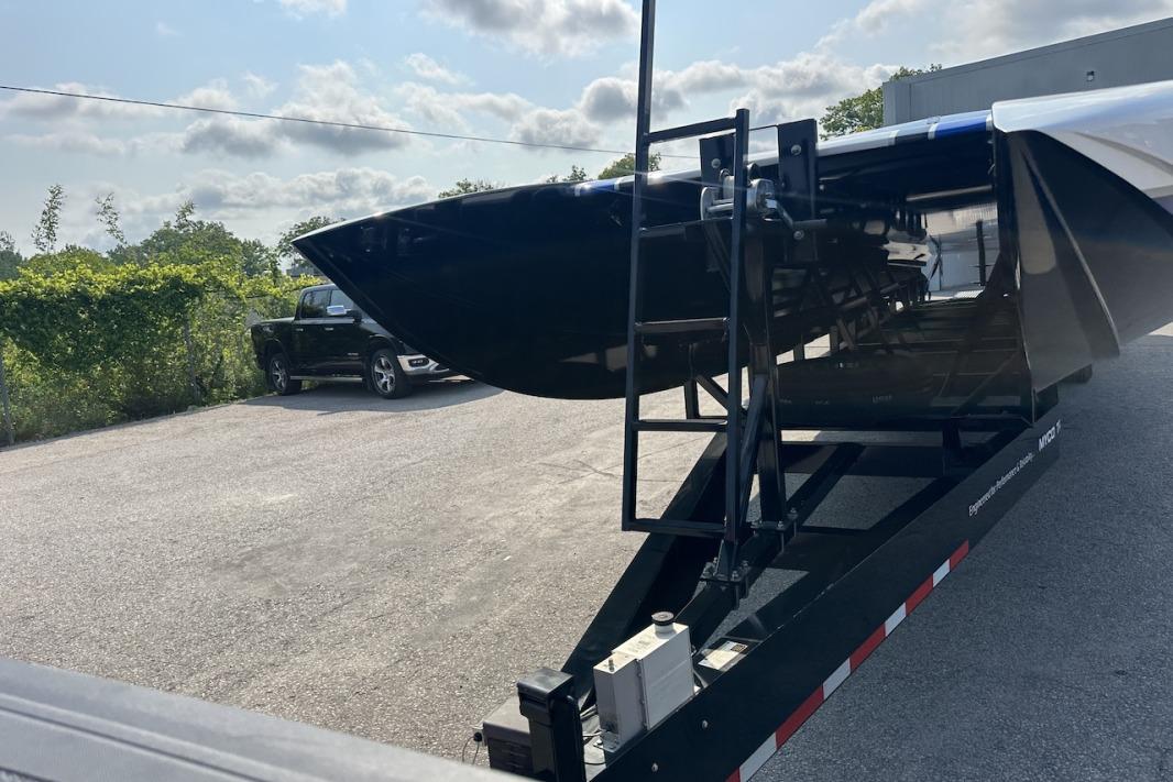 2018 Wright Performance 420 boat on trailer, parked outdoors under a cloudy sky.