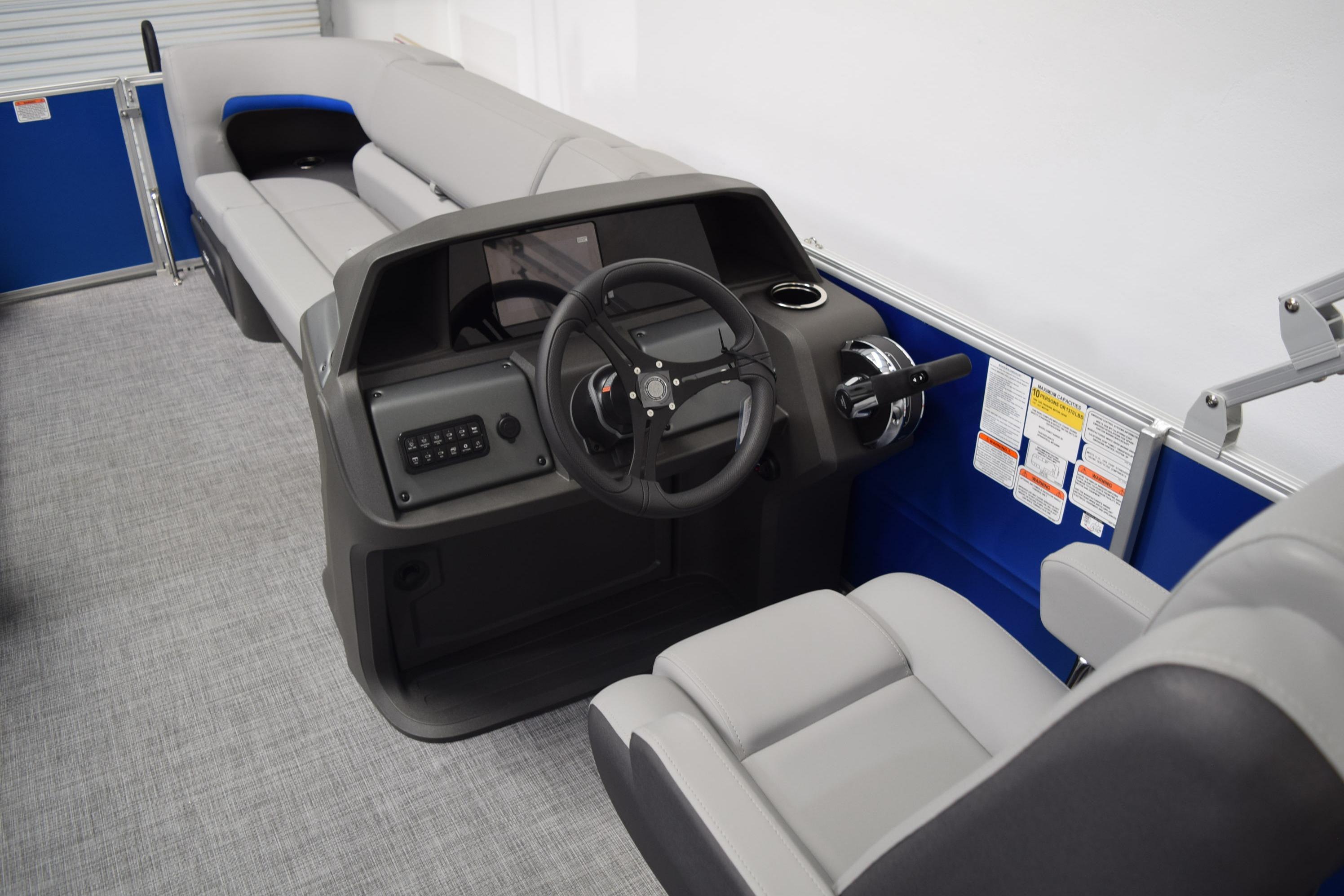 2026 Sun Tracker Party Barge 20 DLX interior with steering console and seating.
