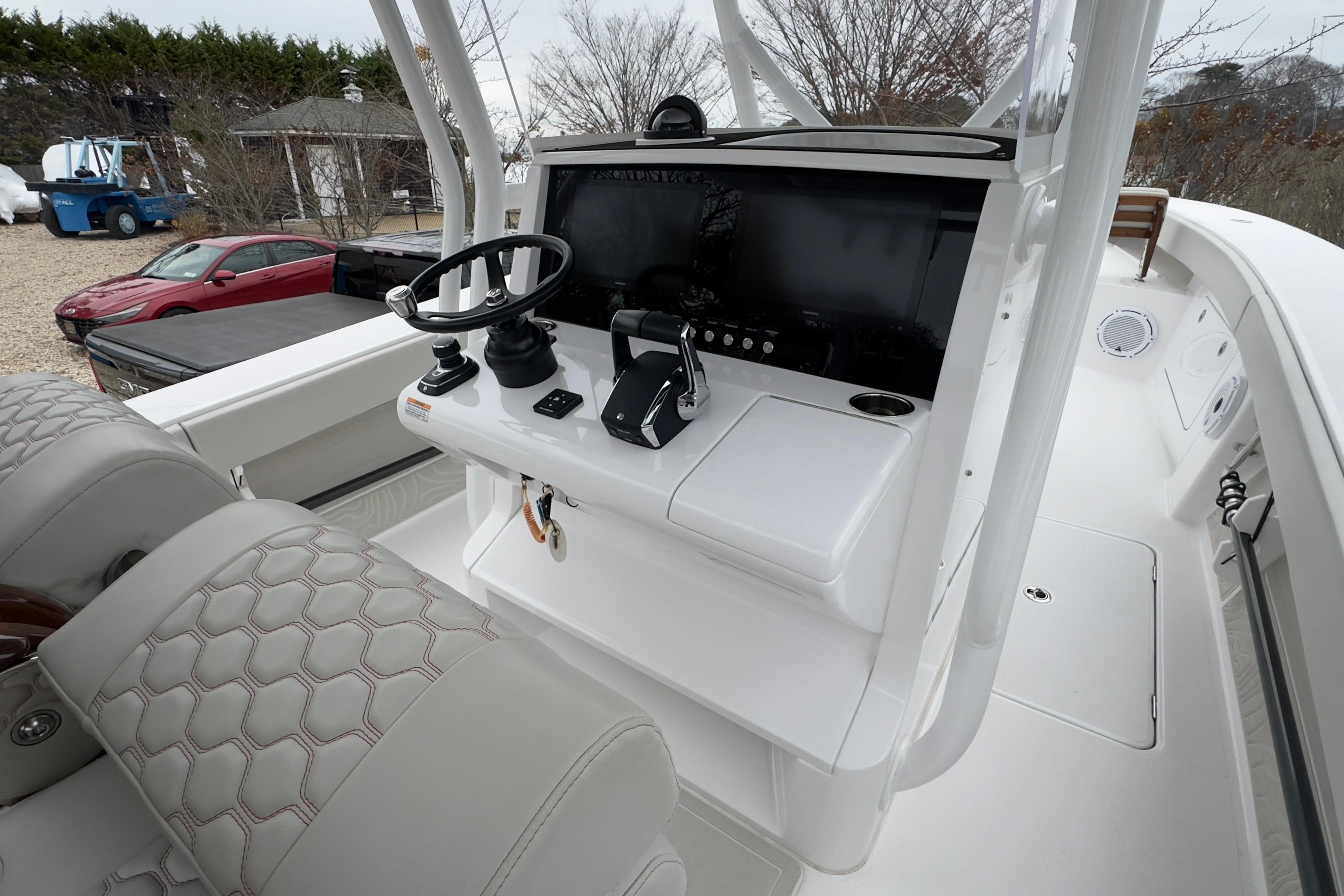 2024 Jupiter 32 FS boat cockpit with steering wheel and control panel.
