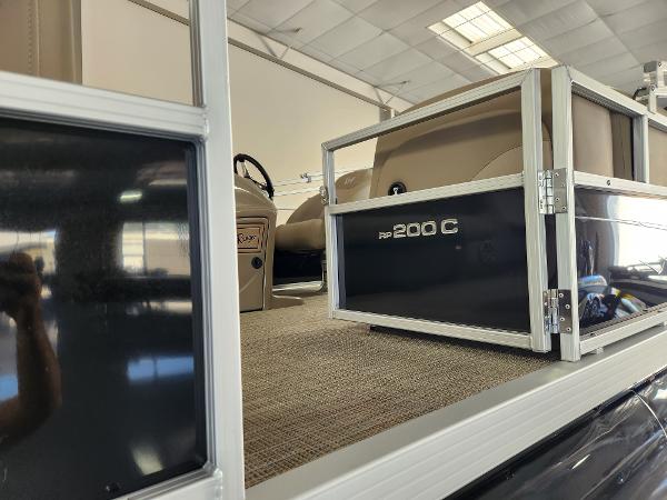 2025 Ranger 200C boat interior with seating and steering wheel in a showroom.