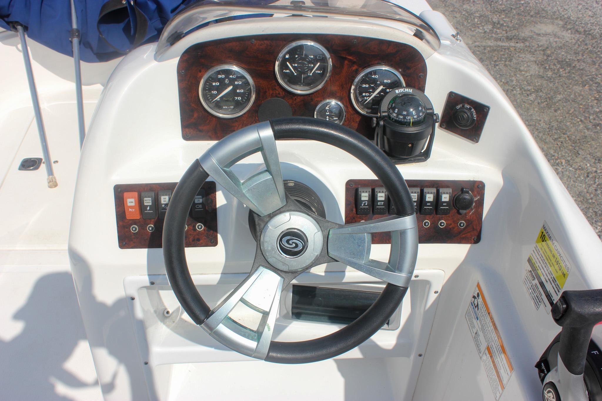 2013 Hurricane SunDeck Sport 188 OB boat dashboard with steering wheel and control panel.