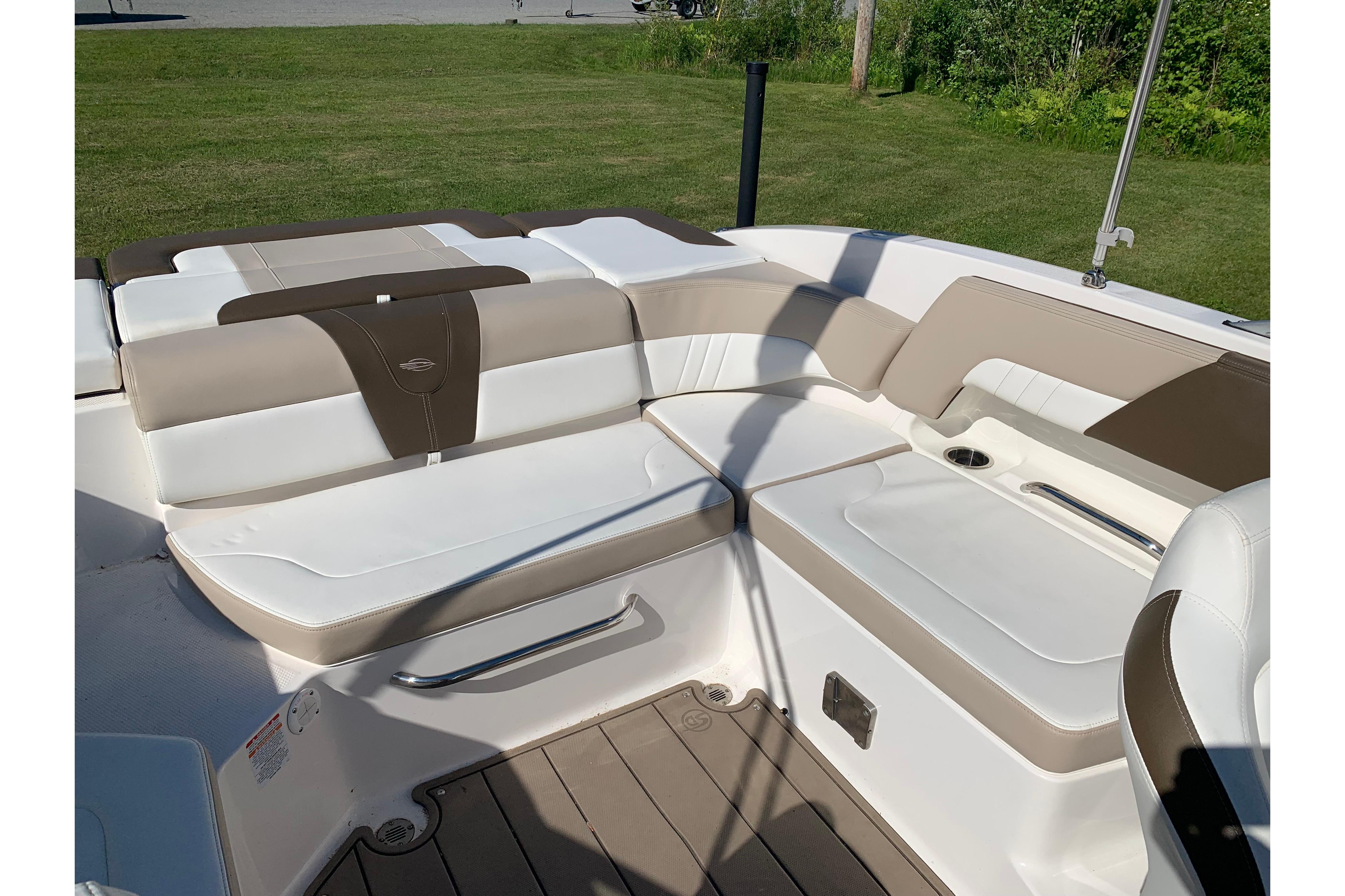 2022 Chaparral 23 SSi boat interior with beige and white seating.