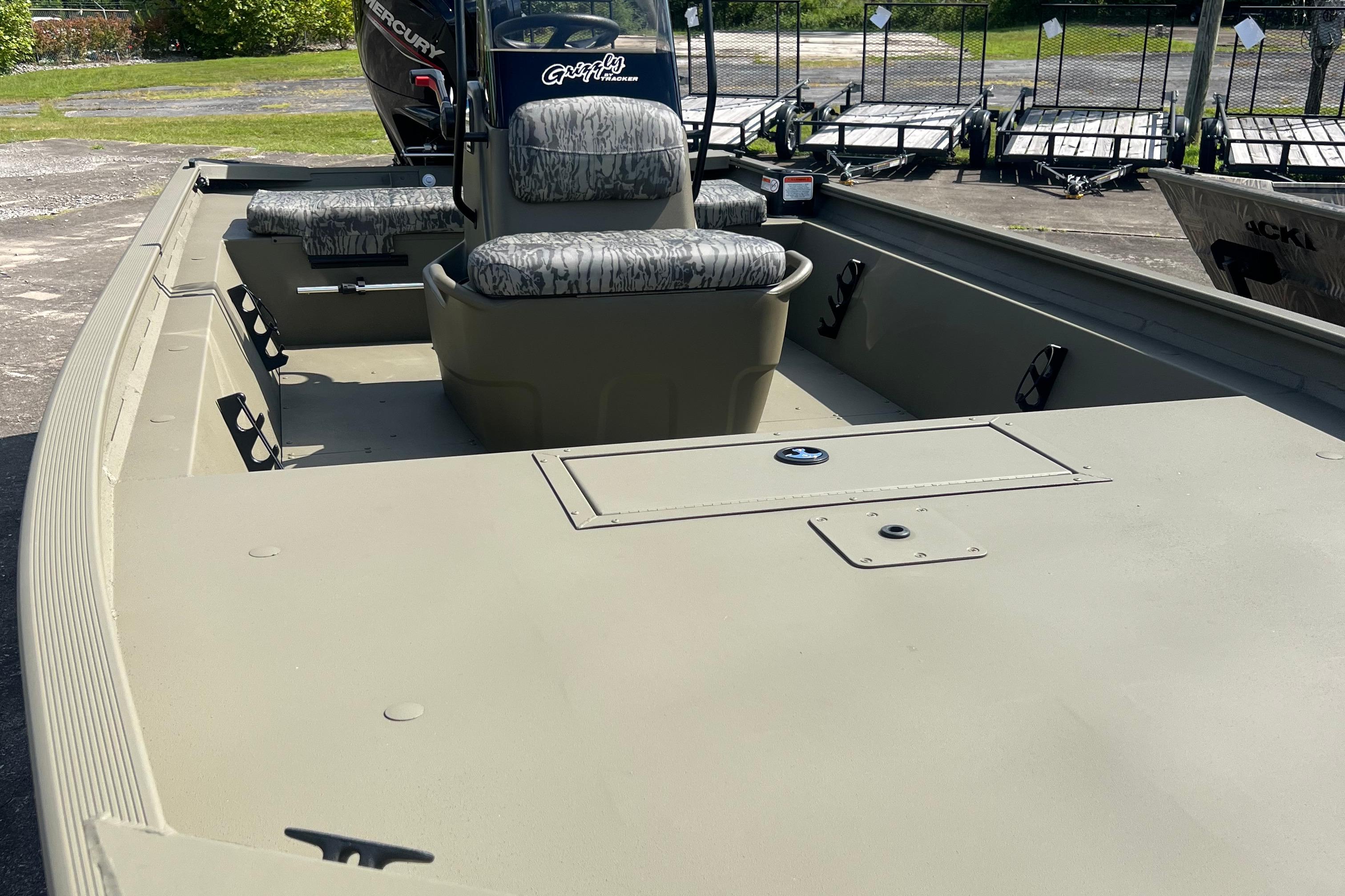2026 Tracker Grizzly 1860 CC boat interior with camo seats and spacious deck.