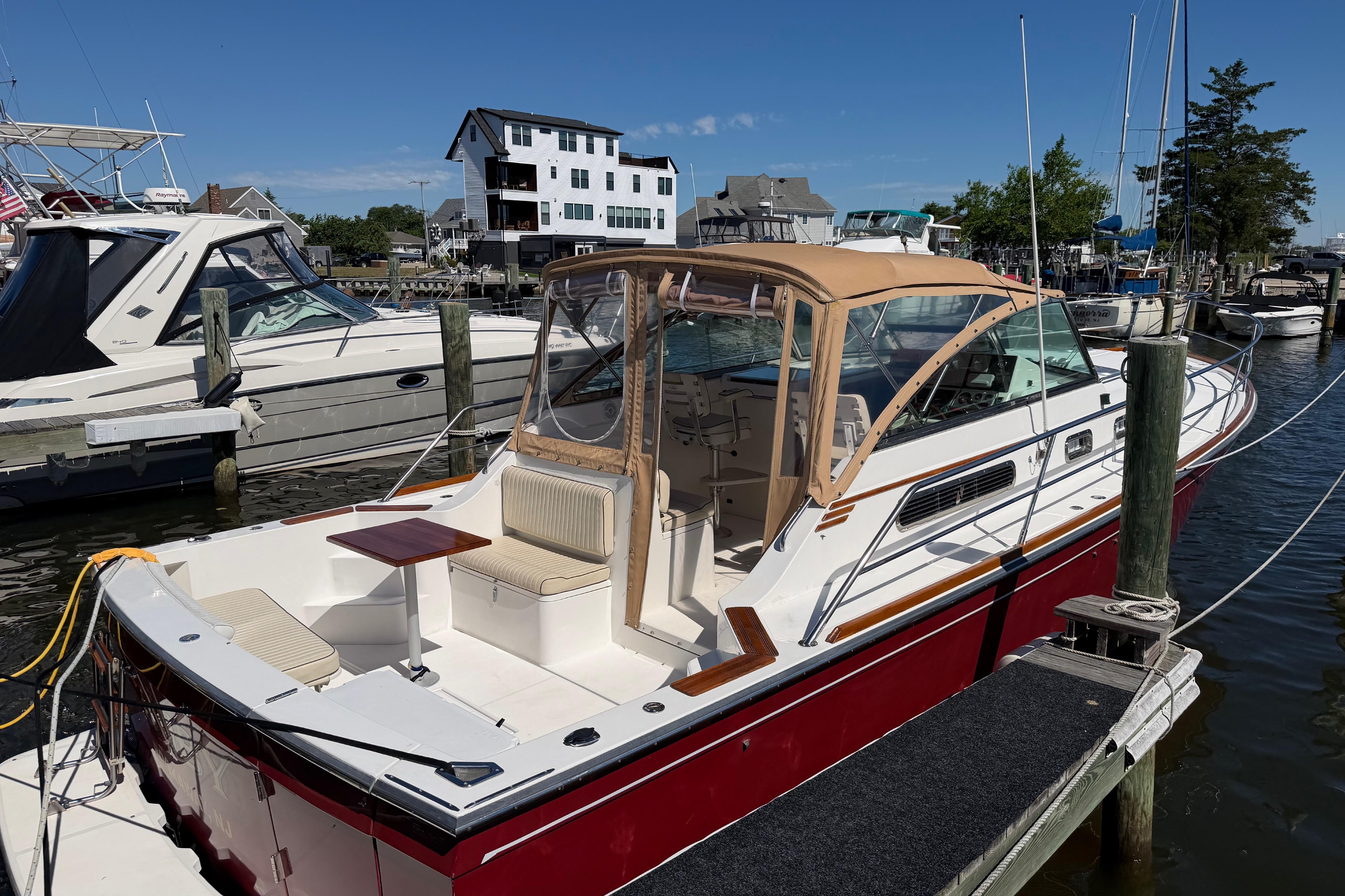 2000 Sabreline 36 Express boat docked at marina, featuring sleek design and spacious deck.