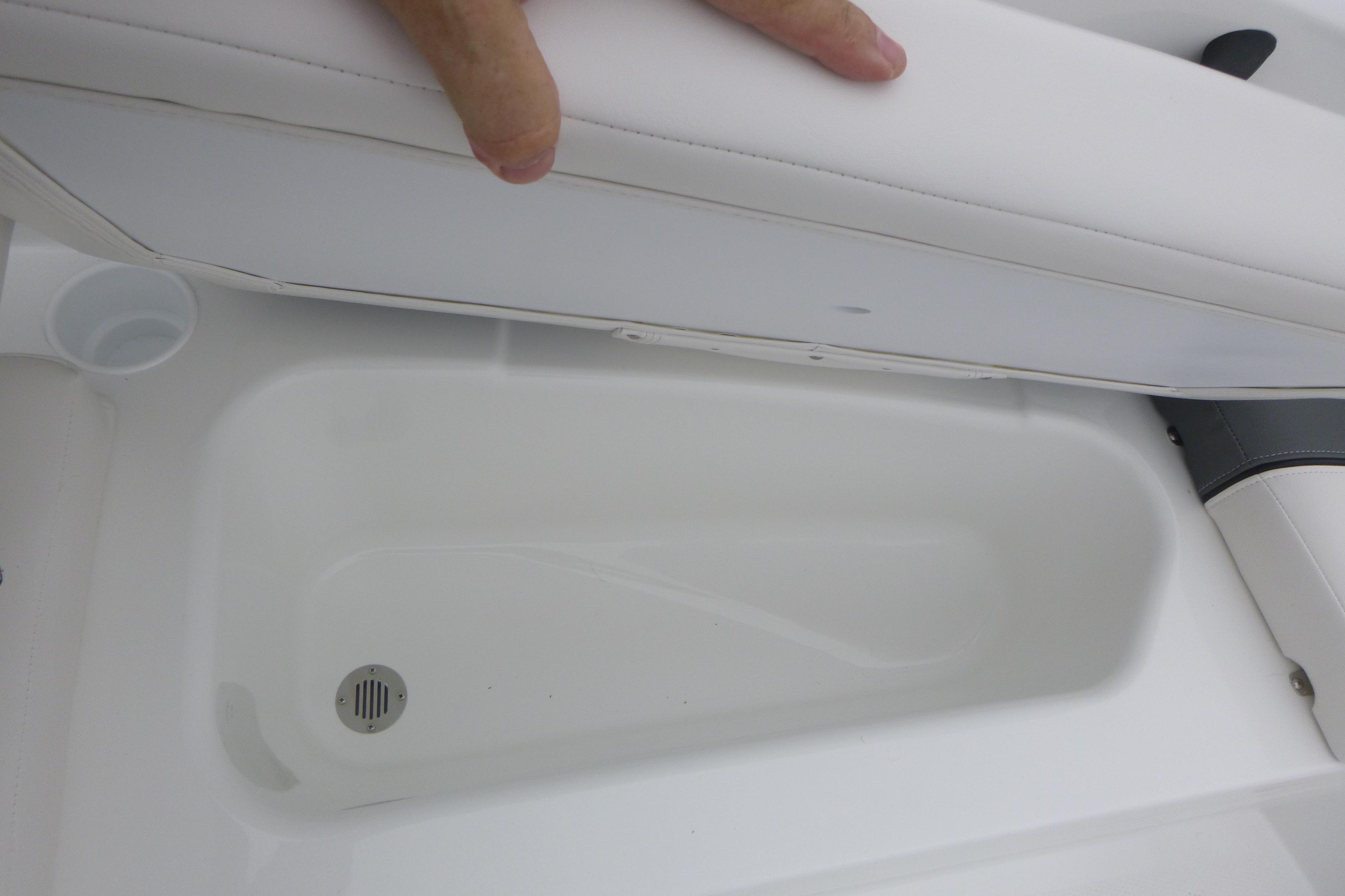 2026 Tahoe T16 boat storage compartment with white cushioned seat.