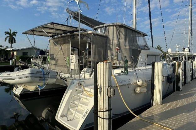 2010 Lagoon 421 catamaran docked at marina, featuring spacious deck and modern design.