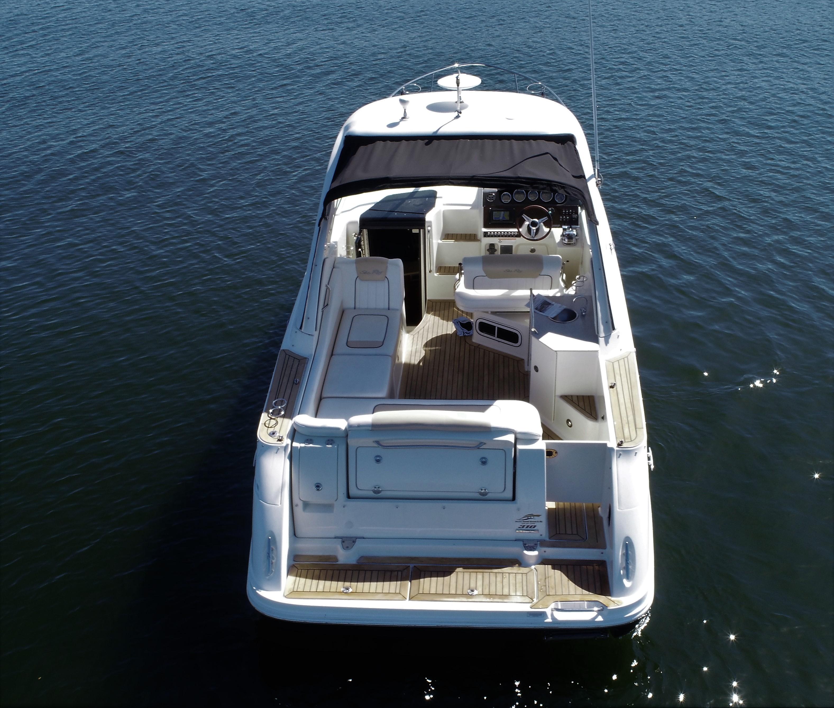 2010 Sea Ray 310 Sundancer boat on calm water, rear view.