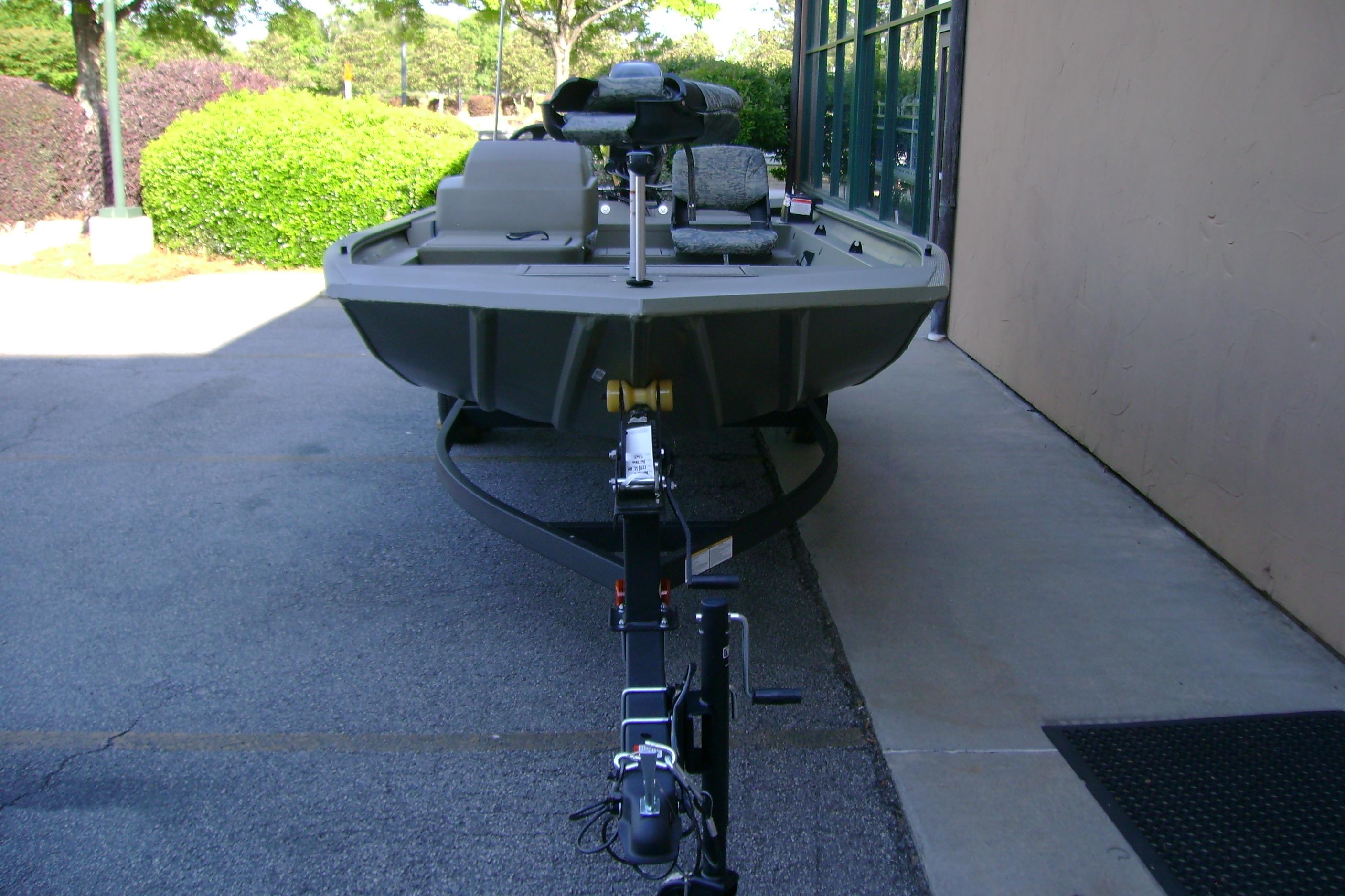 2026 Tracker Grizzly 1754 SC boat on trailer, parked outdoors.