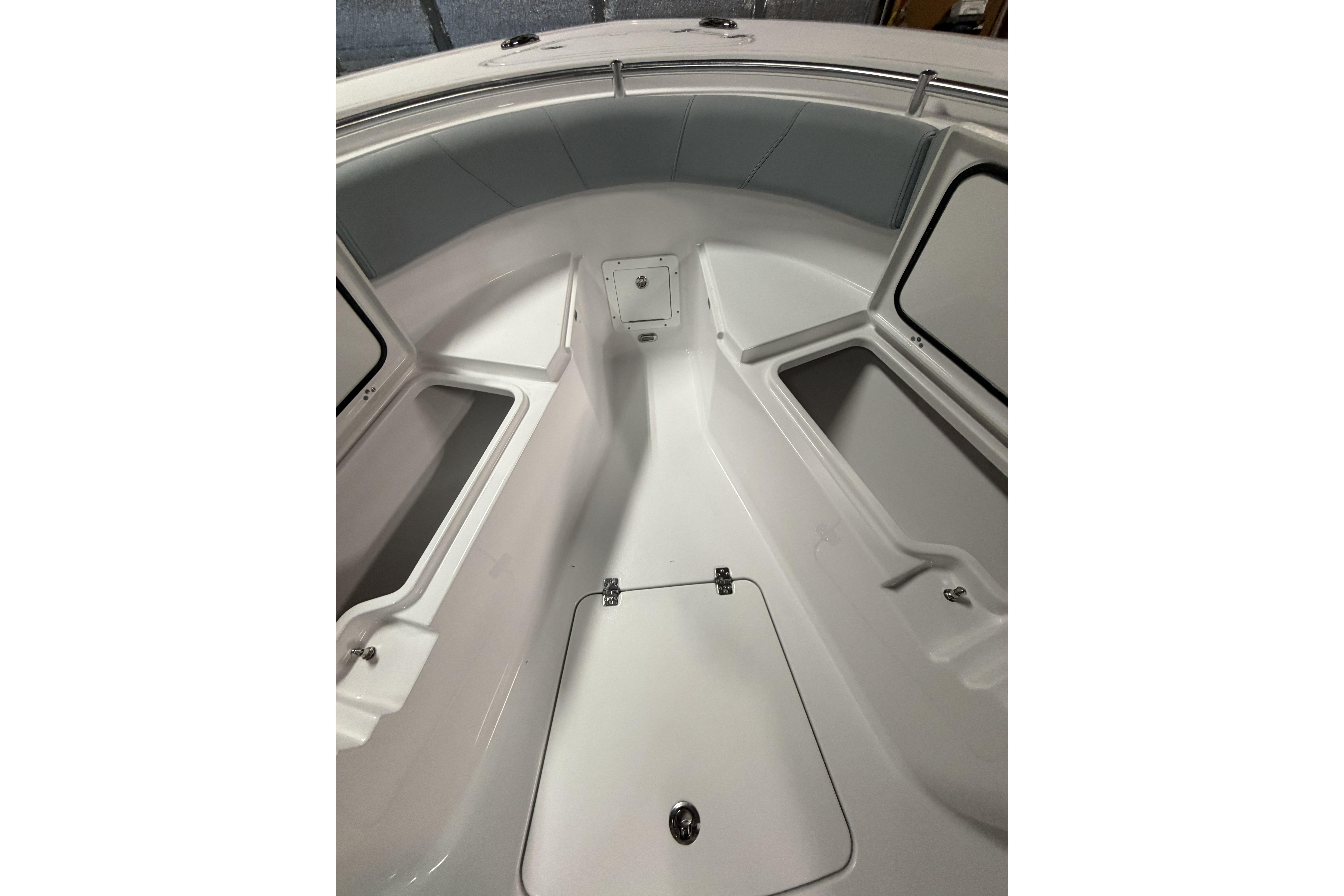 2026 Sportsman Open 232 Center Console boat interior with storage compartments and seating.