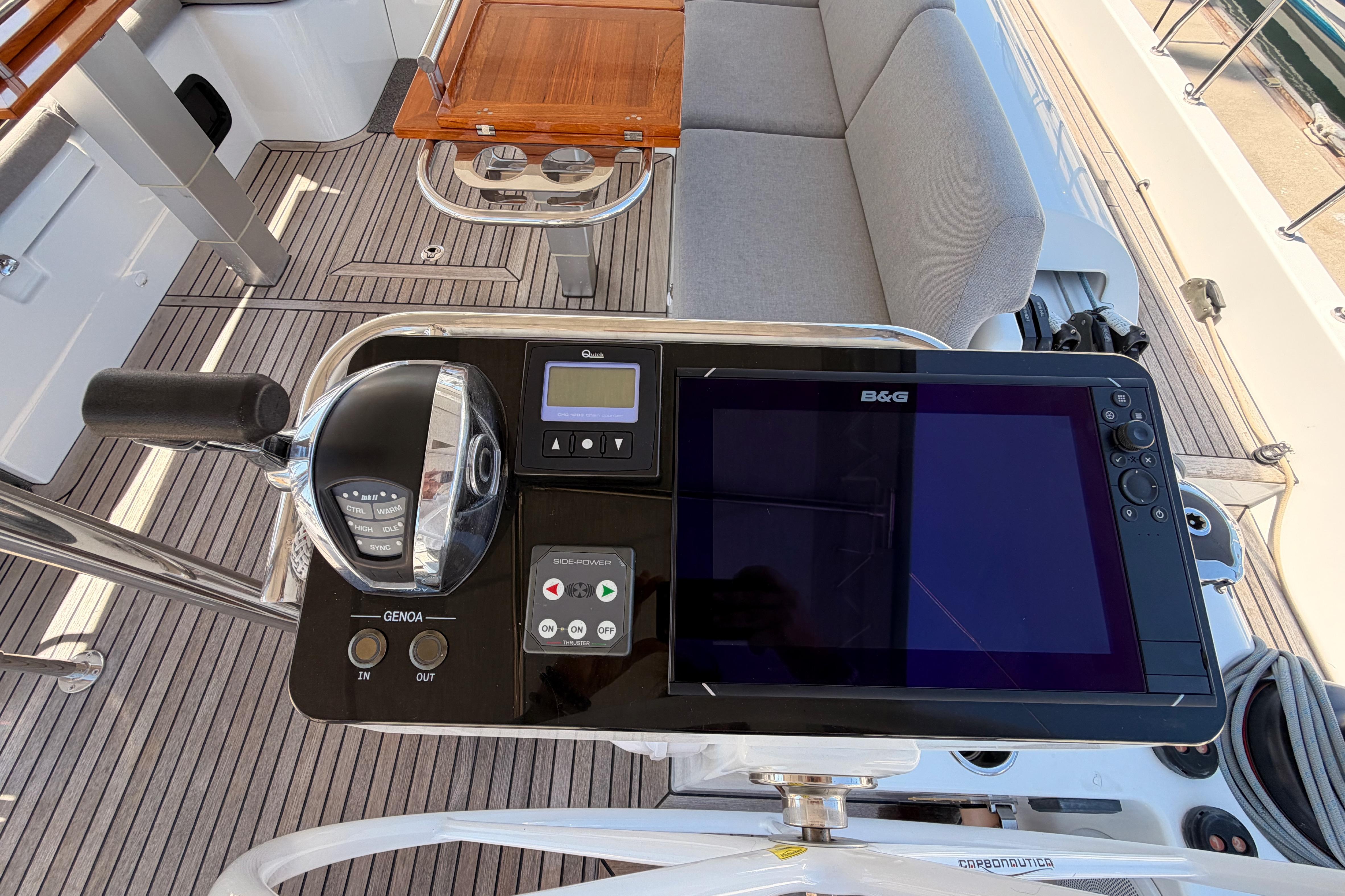 Control panel of 2022 Beneteau Oceanis Yacht 54 with navigation display and throttle.