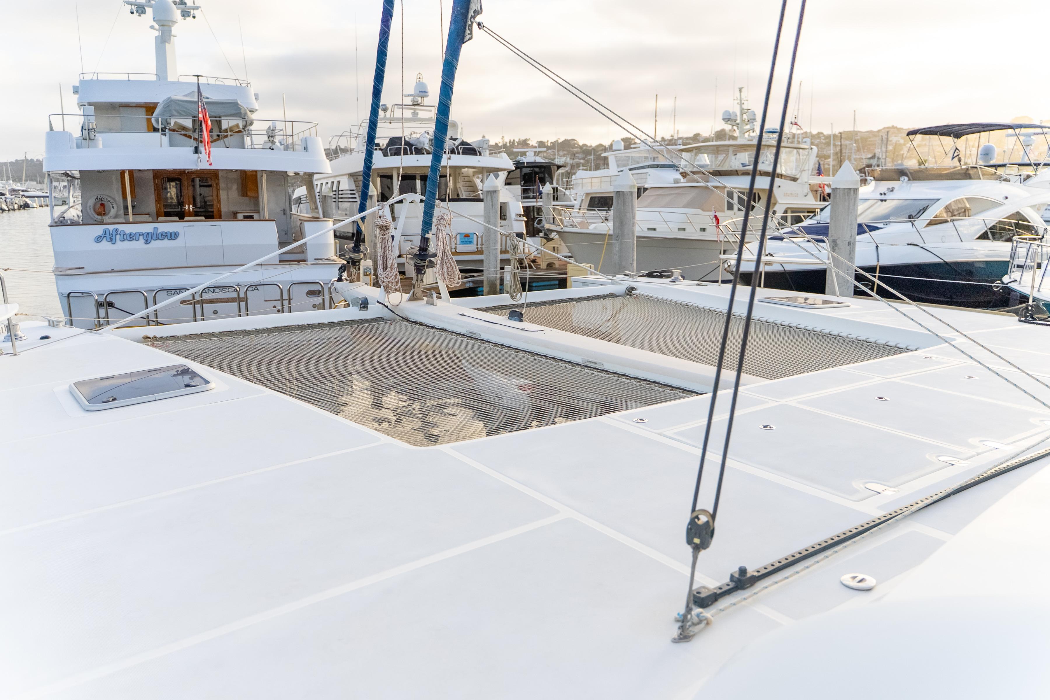 Catana 65 yacht from 2009 docked in a marina with other boats.