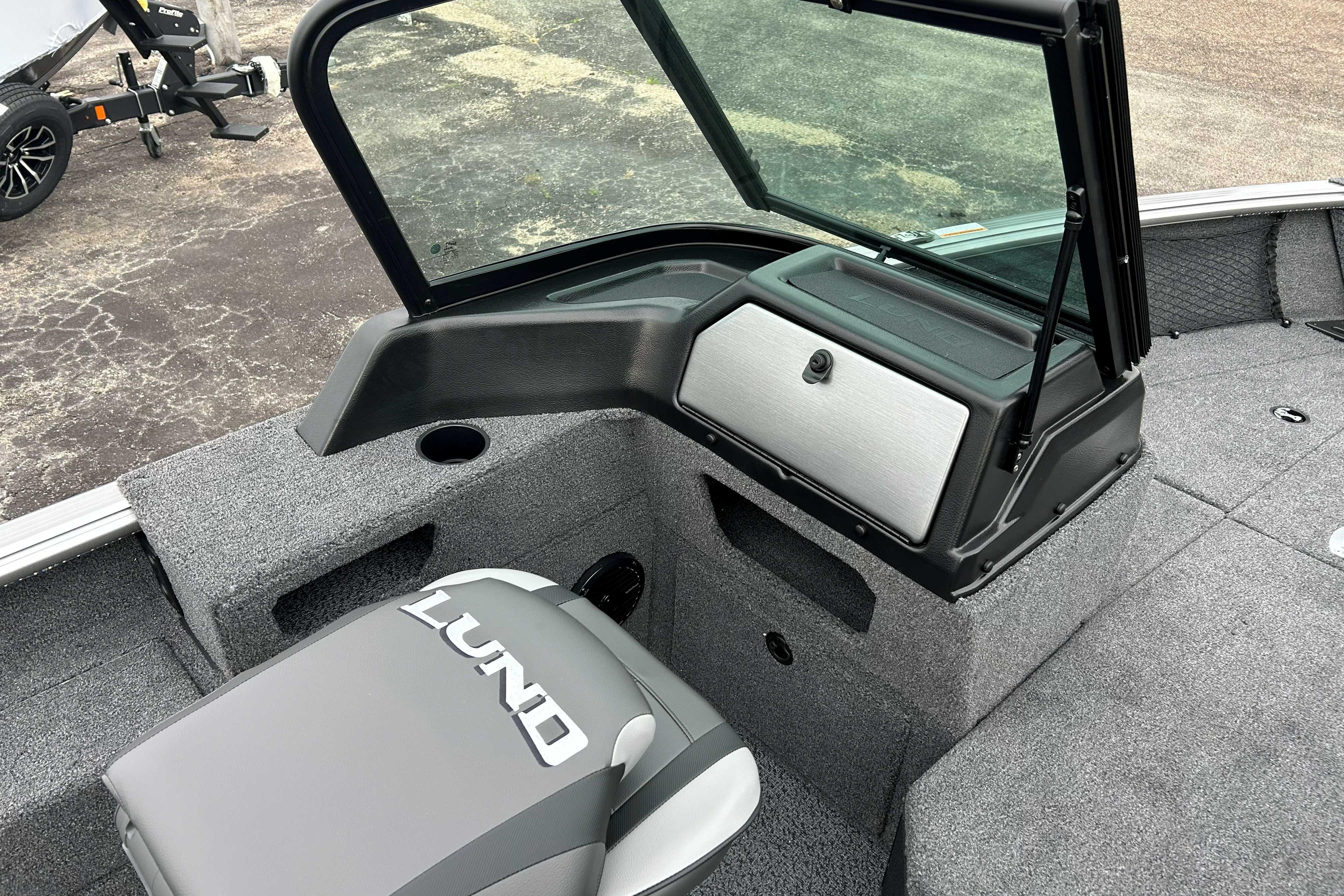2027 Lund 1775 Impact XS boat interior with windshield and storage compartment.