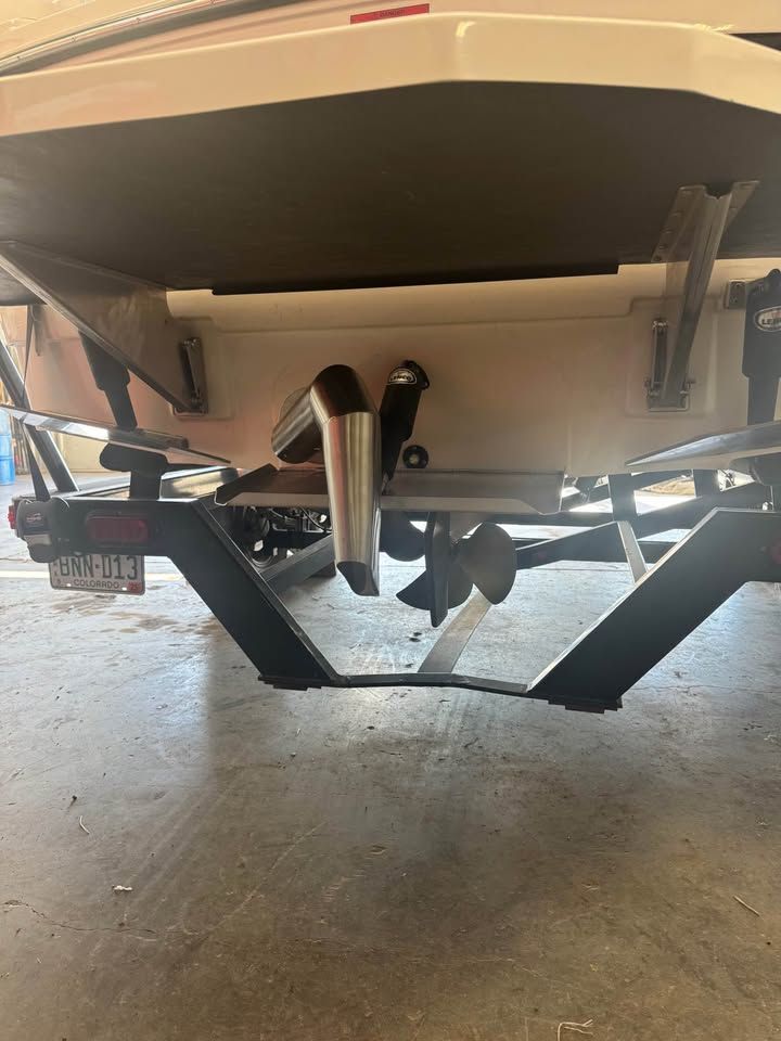 Rear view of a 2015 Moomba Mojo with visible propeller and trailer.