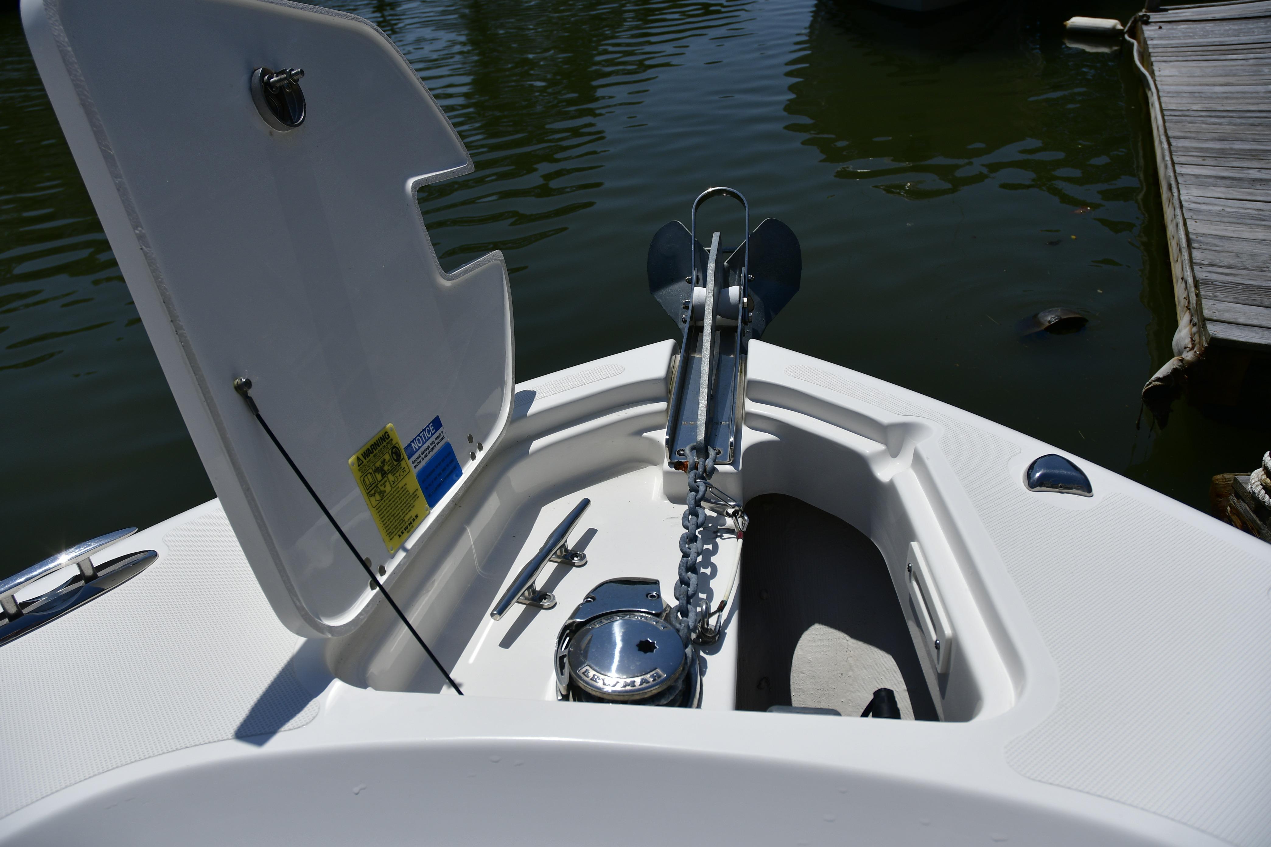 2020 Pursuit C 238 Center Console boat anchor compartment with open hatch.