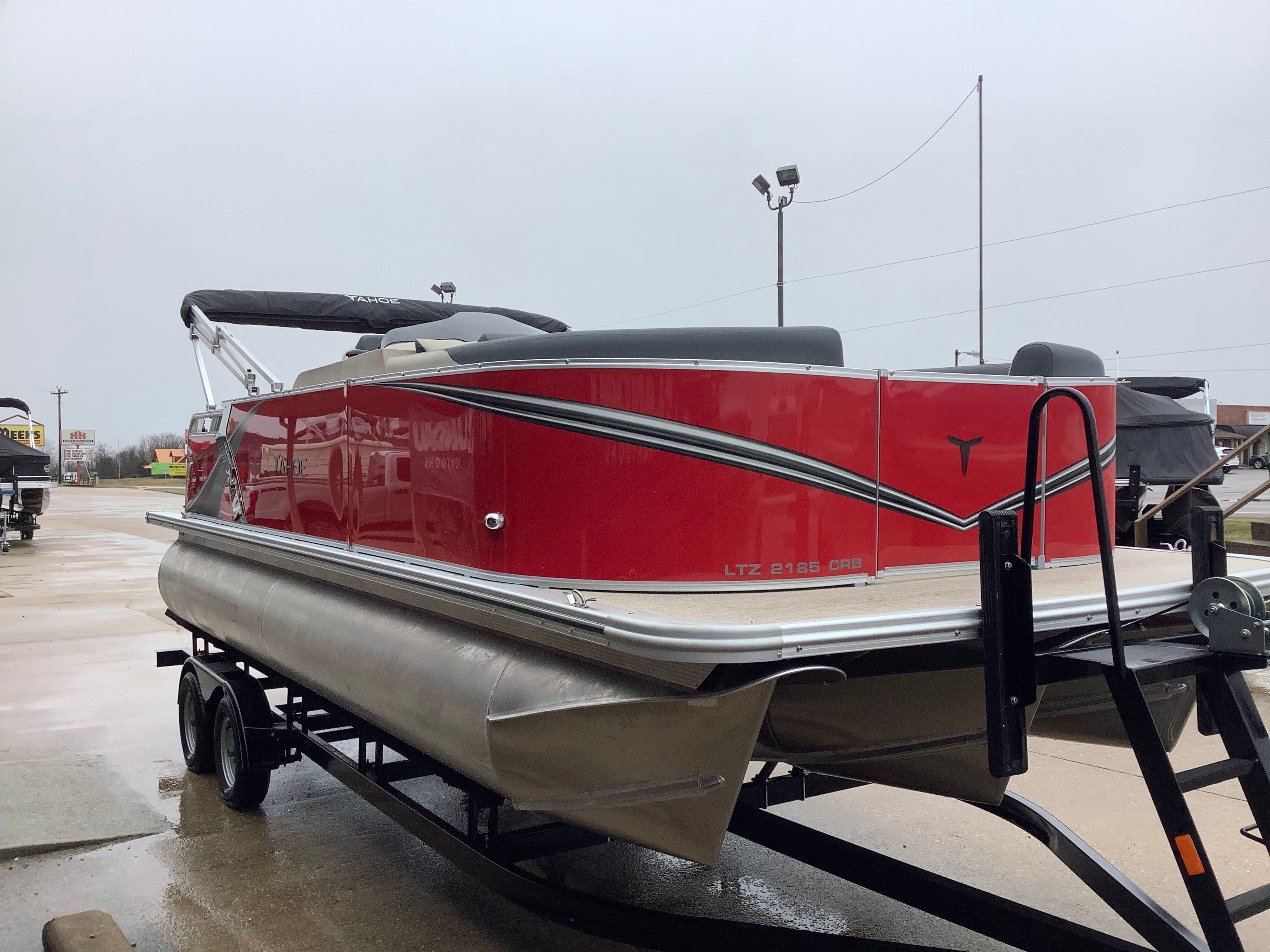 Red 2026 Tahoe 2185 LTZ pontoon boat on trailer.