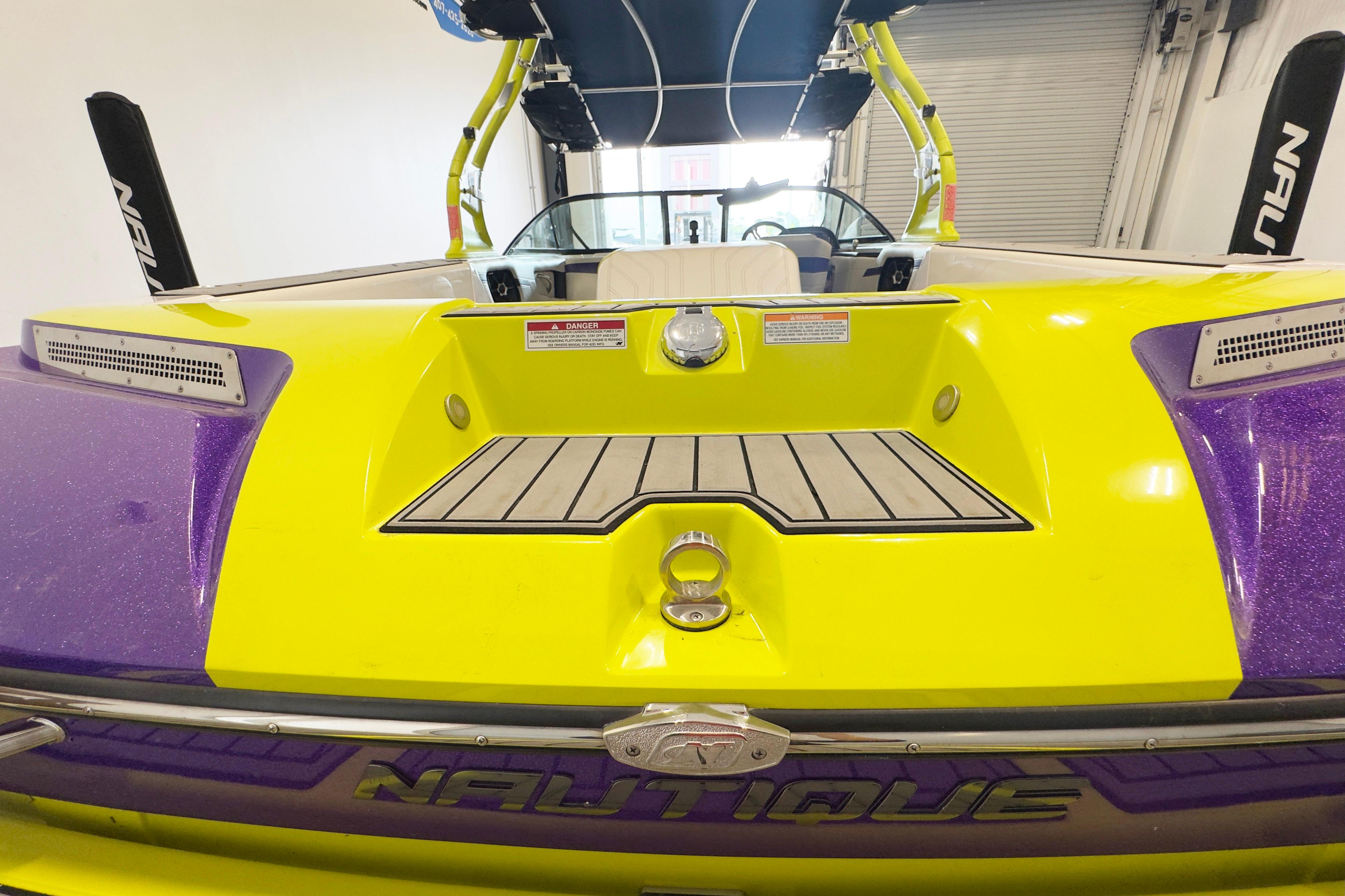 2014 Nautique Ski Nautique 200 Closed Bow, vibrant yellow and purple design, rear view.