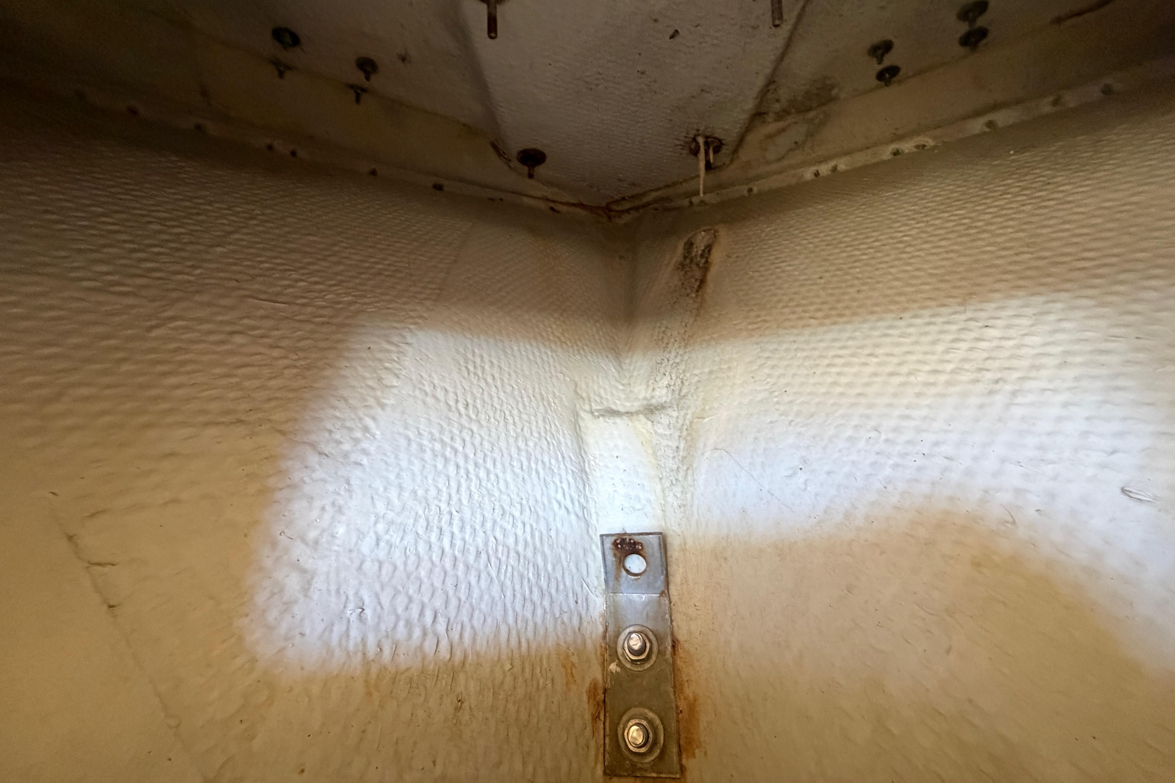 Interior view of 2006 Grady-White Sailfish 282 boat hull with visible screws and metal bracket.