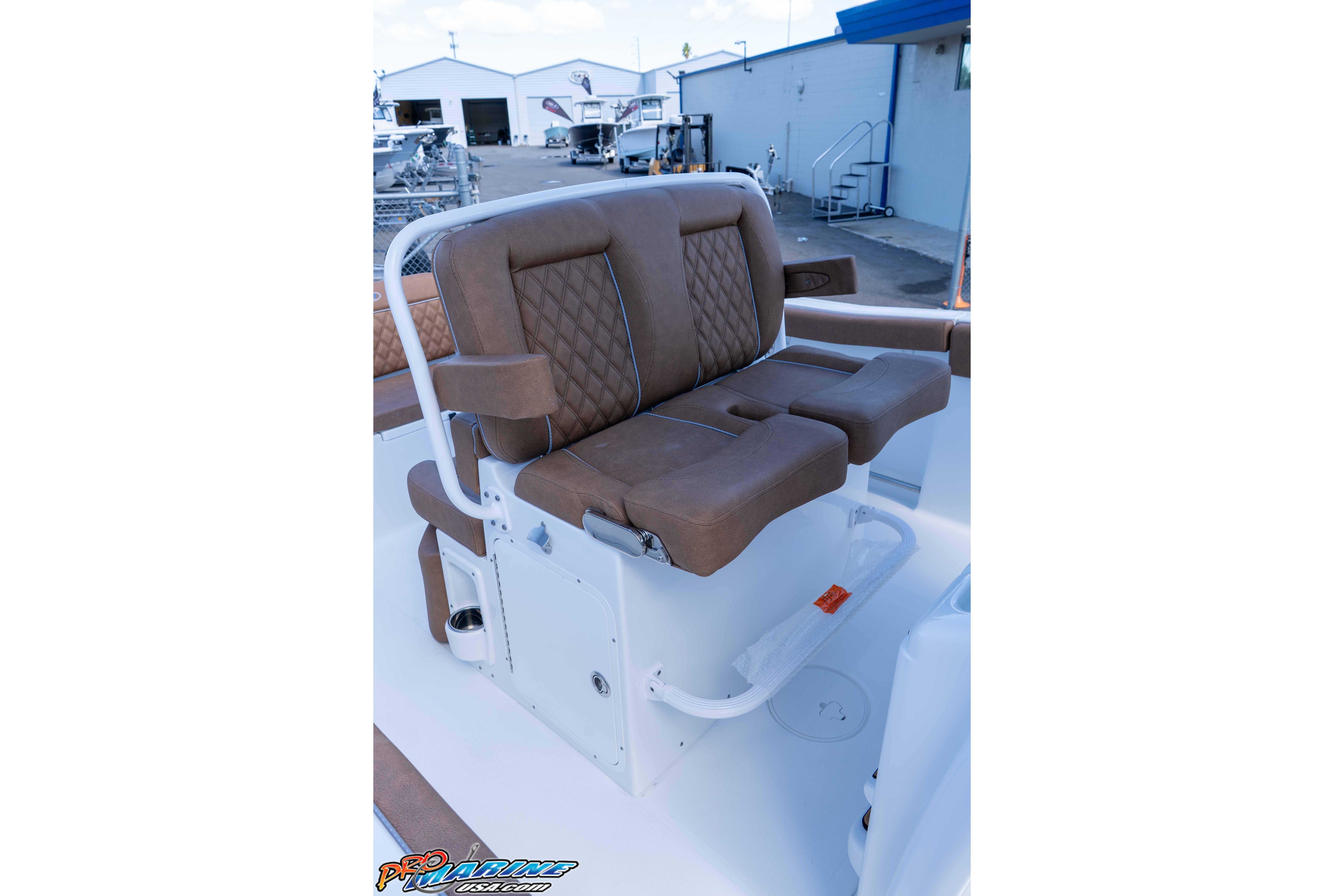 2026 Sea Hunt Ultra 255 SE boat seating with brown cushioned seats and white frame.
