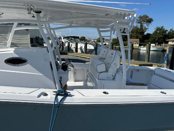 2025 Southport 33 FE boat docked, featuring spacious seating and sleek design.