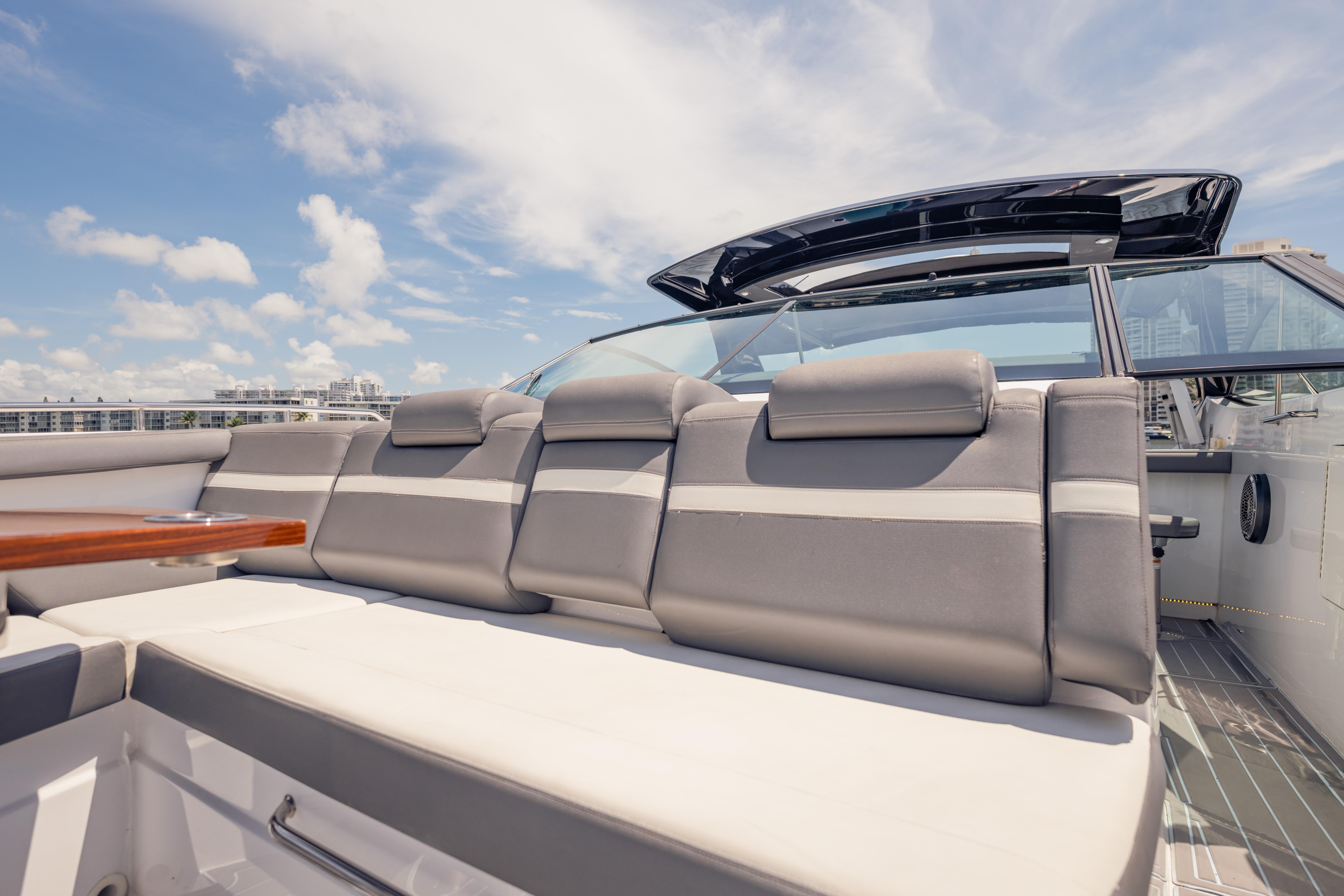 2021 Cruisers Yachts 38 GLS luxury seating area under clear blue sky.