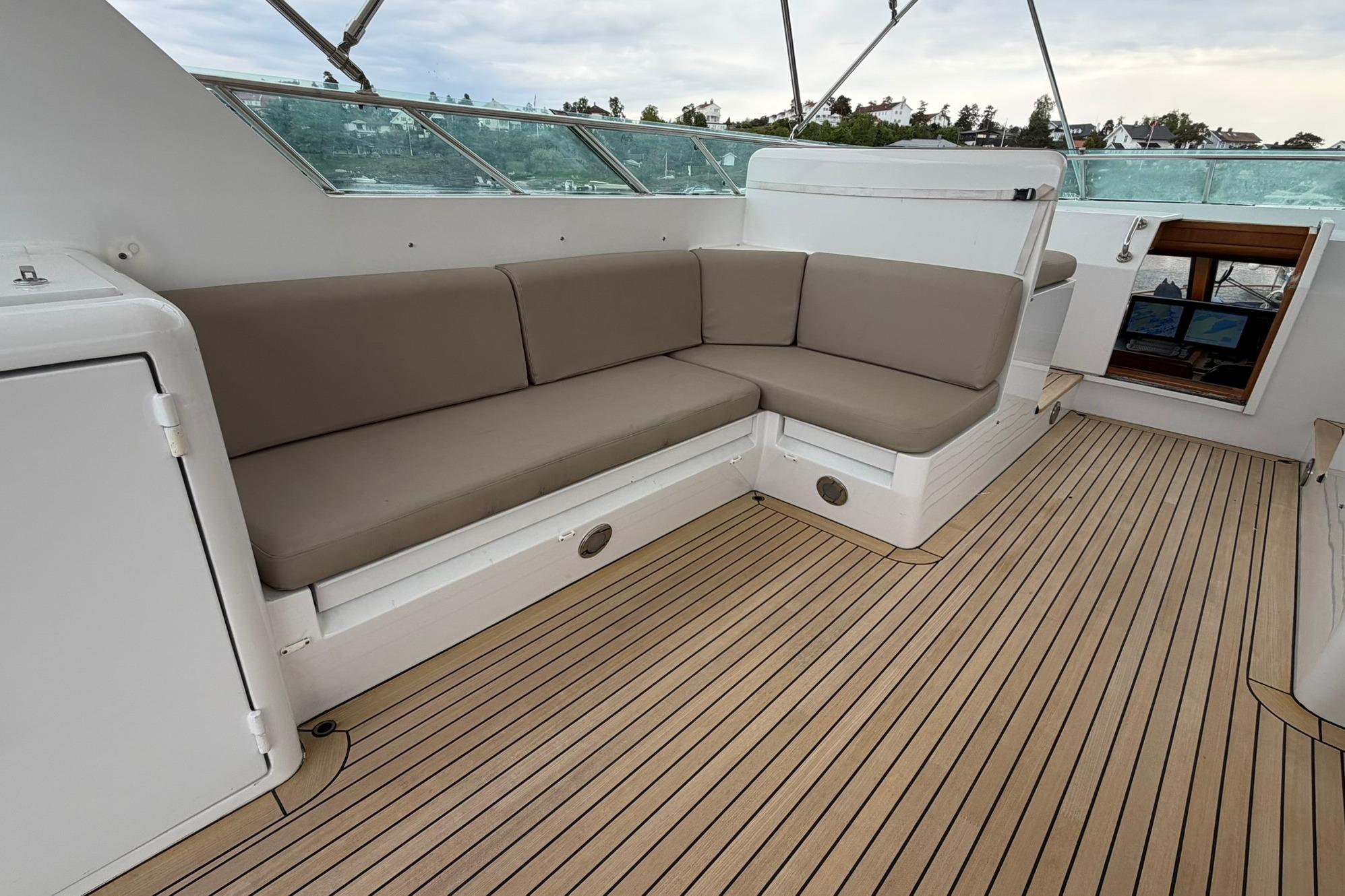 Spacious seating area on 1990 Lowland Netship 97 yacht with wooden deck and modern design.