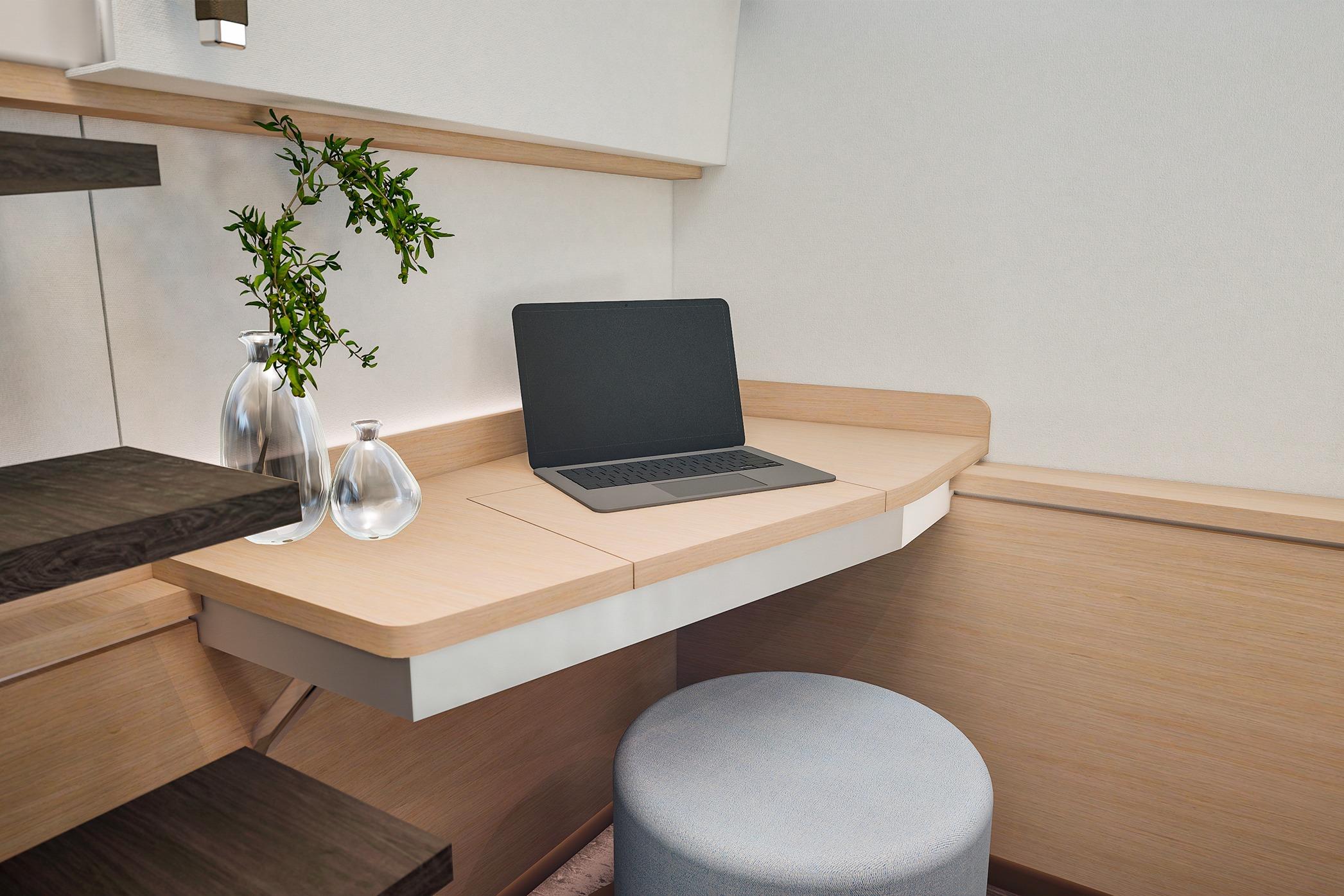 Modern workspace on 2026 Fountaine Pajot FP 55 yacht with laptop and decorative plants.
