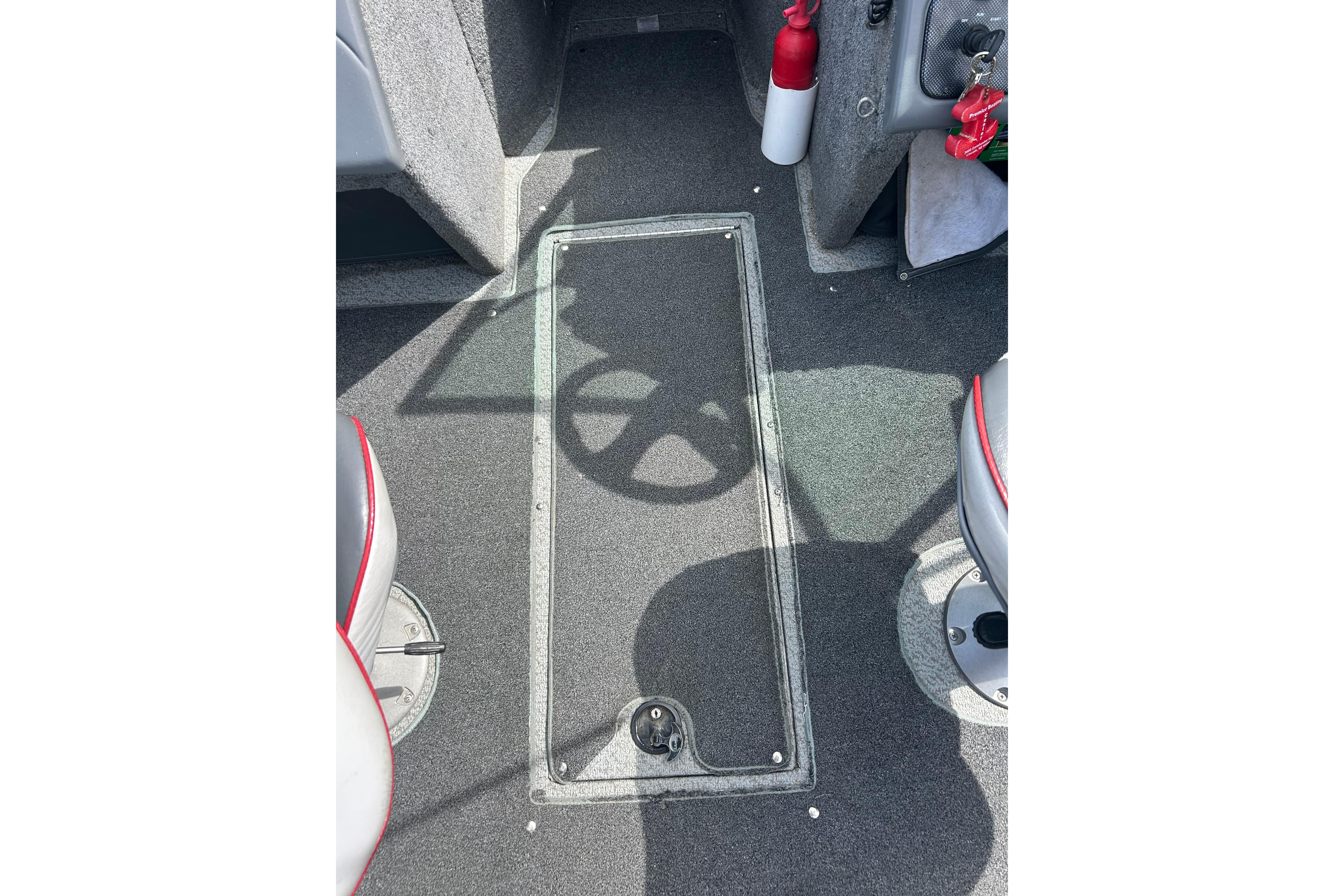 Interior of a 2008 Lund 1850 Fisherman boat, featuring carpeted flooring and seating.