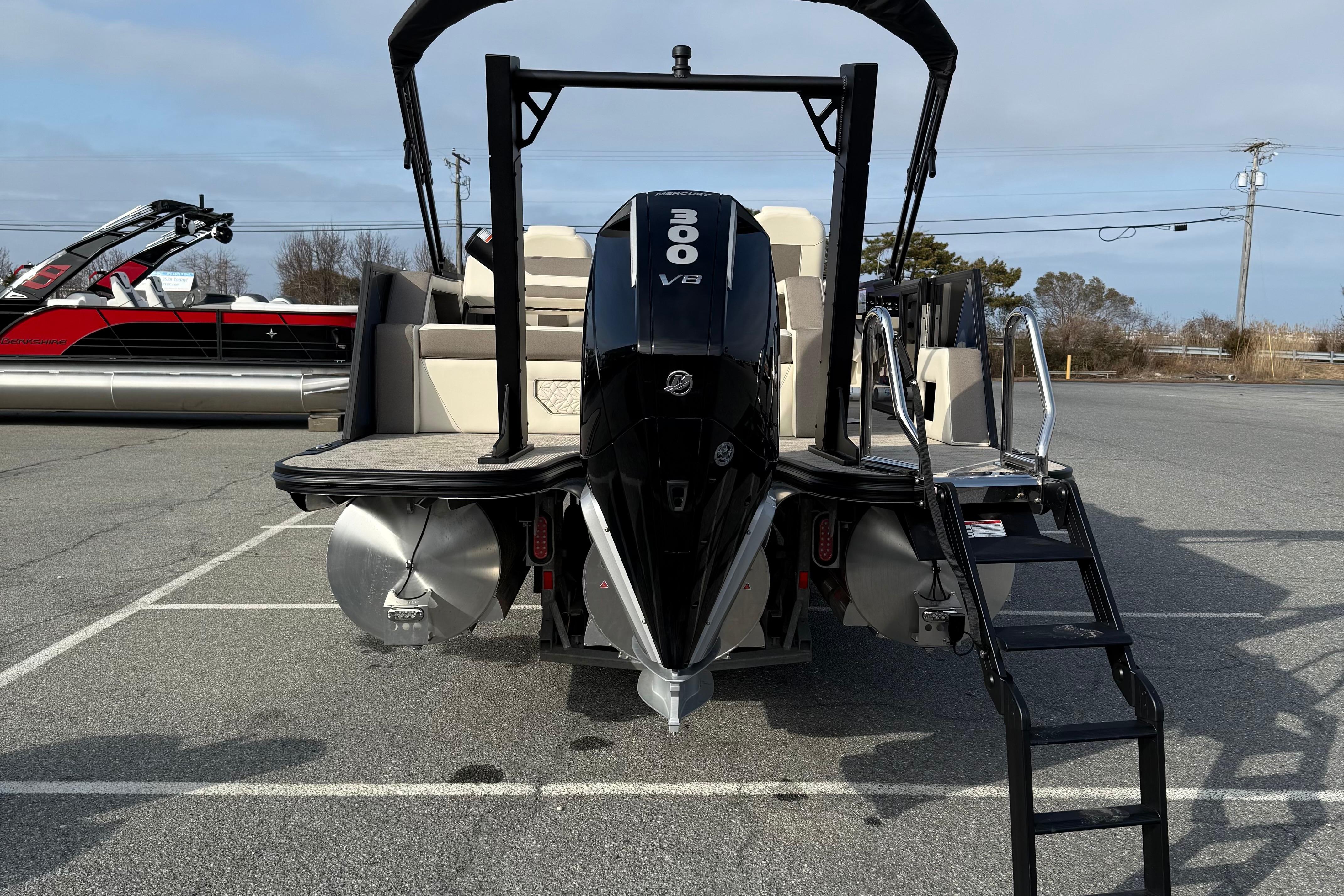 2026 Alera M23L boat with 300 V8 engine, parked on asphalt.