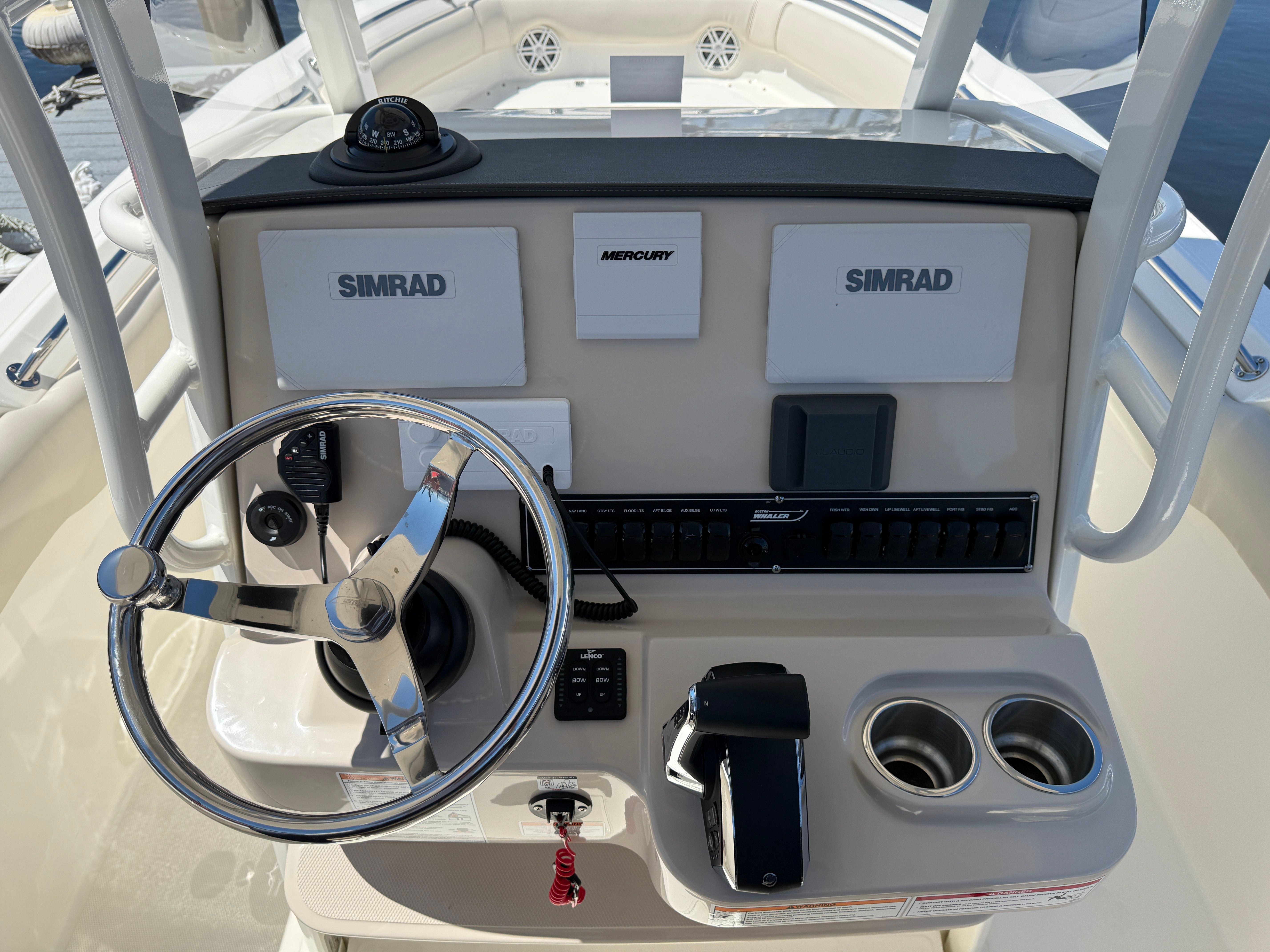 Boston Whaler 230 Outrage 2024 helm with Simrad displays.