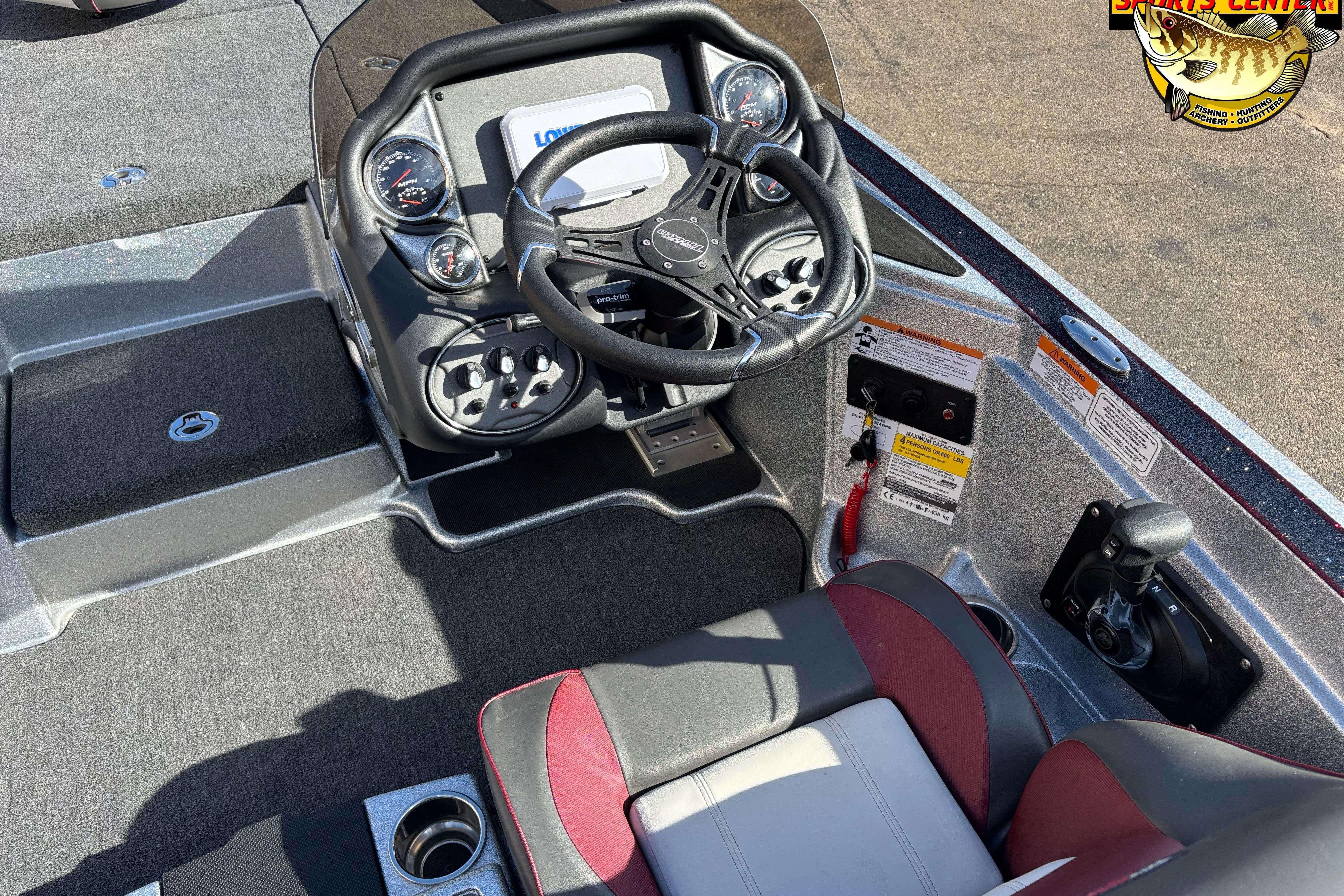 2025 Triton 18 TrX boat cockpit with steering wheel and control panel.