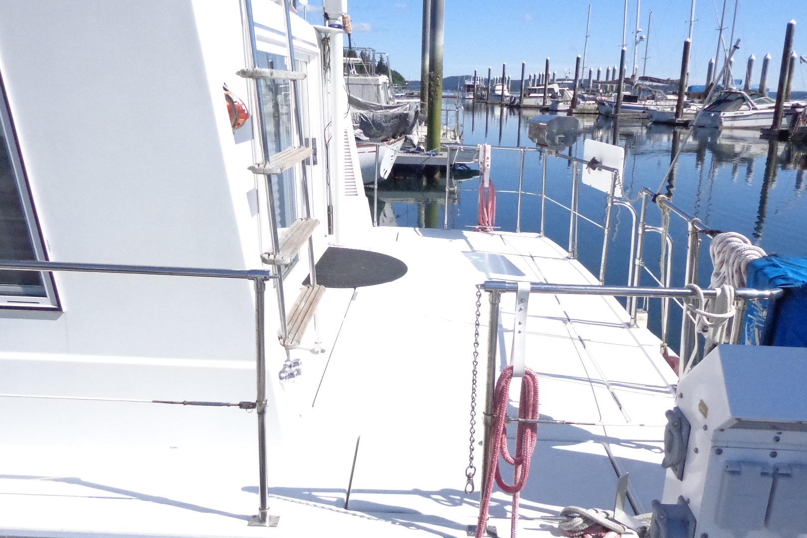 Cruise-A-Home Corsair 4200, 1992 model, docked at a marina with clear blue skies.