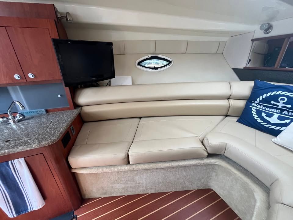 Interior of a 2011 Monterey 280SCR yacht with sofa and kitchenette.