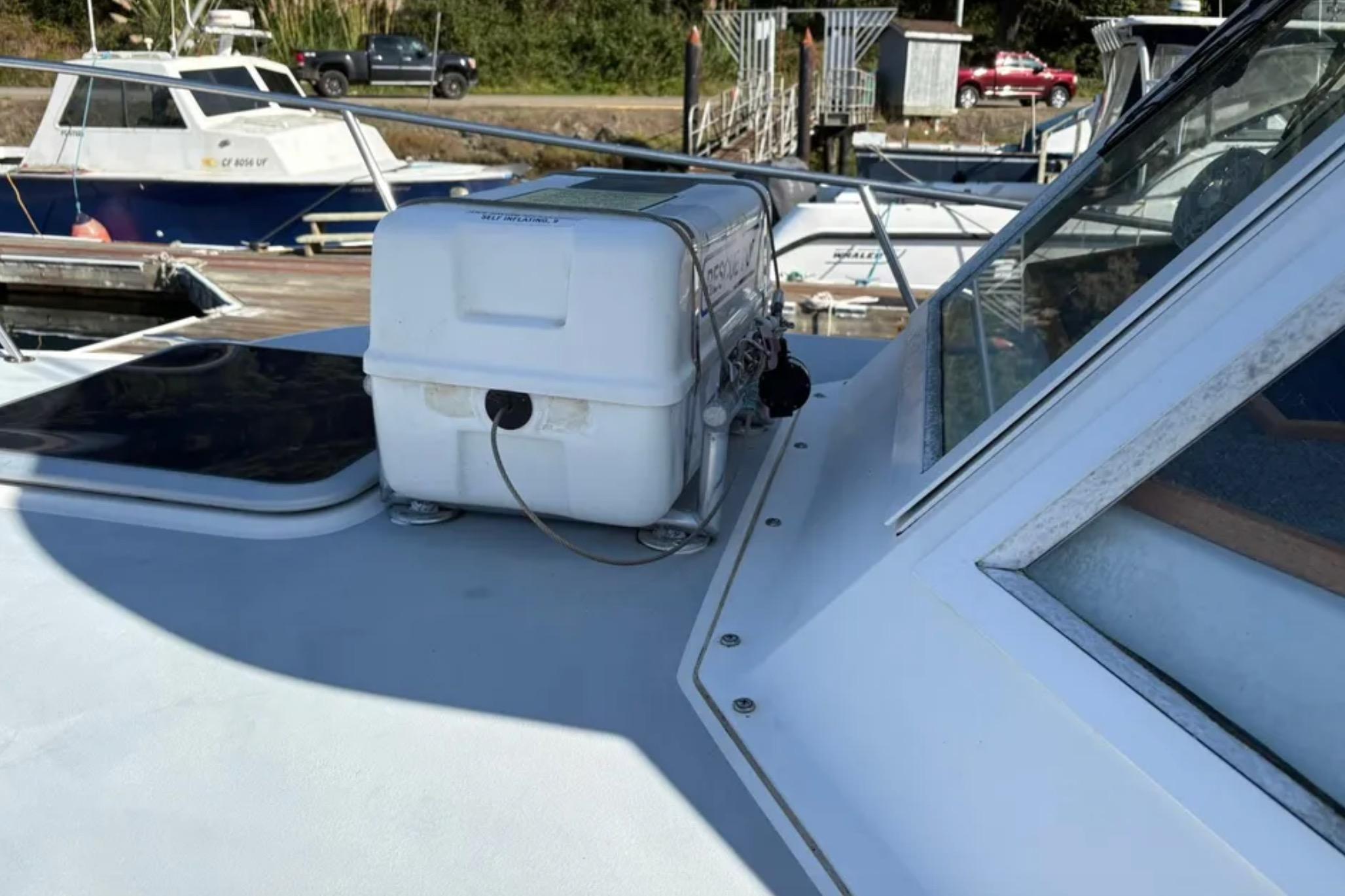 2005 Albin 28 Tournament Express boat docked, featuring deck equipment and nearby vessels.