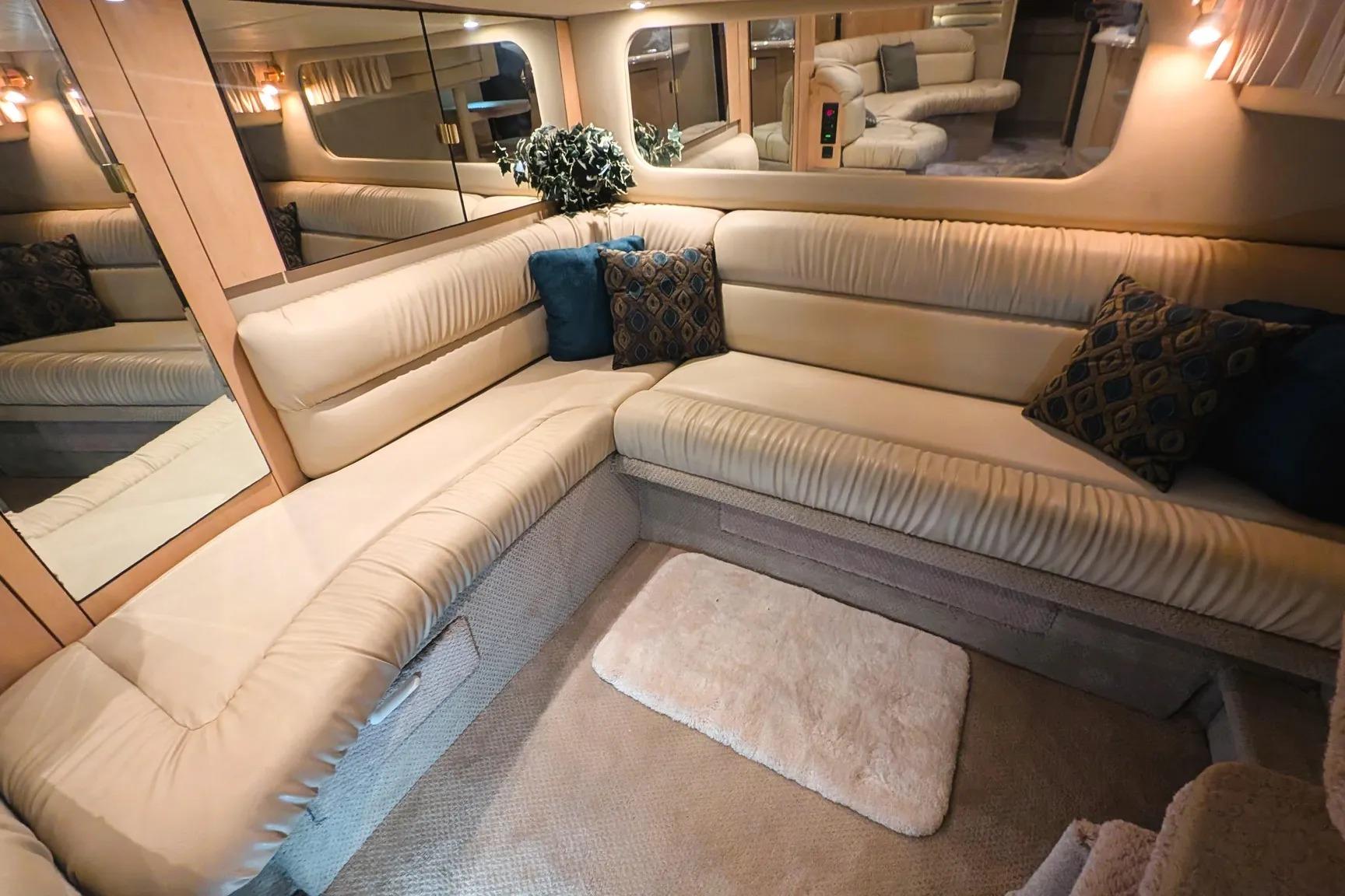 Luxurious interior of 2000 Sea Ray 380 Sundancer yacht with plush seating and elegant decor.