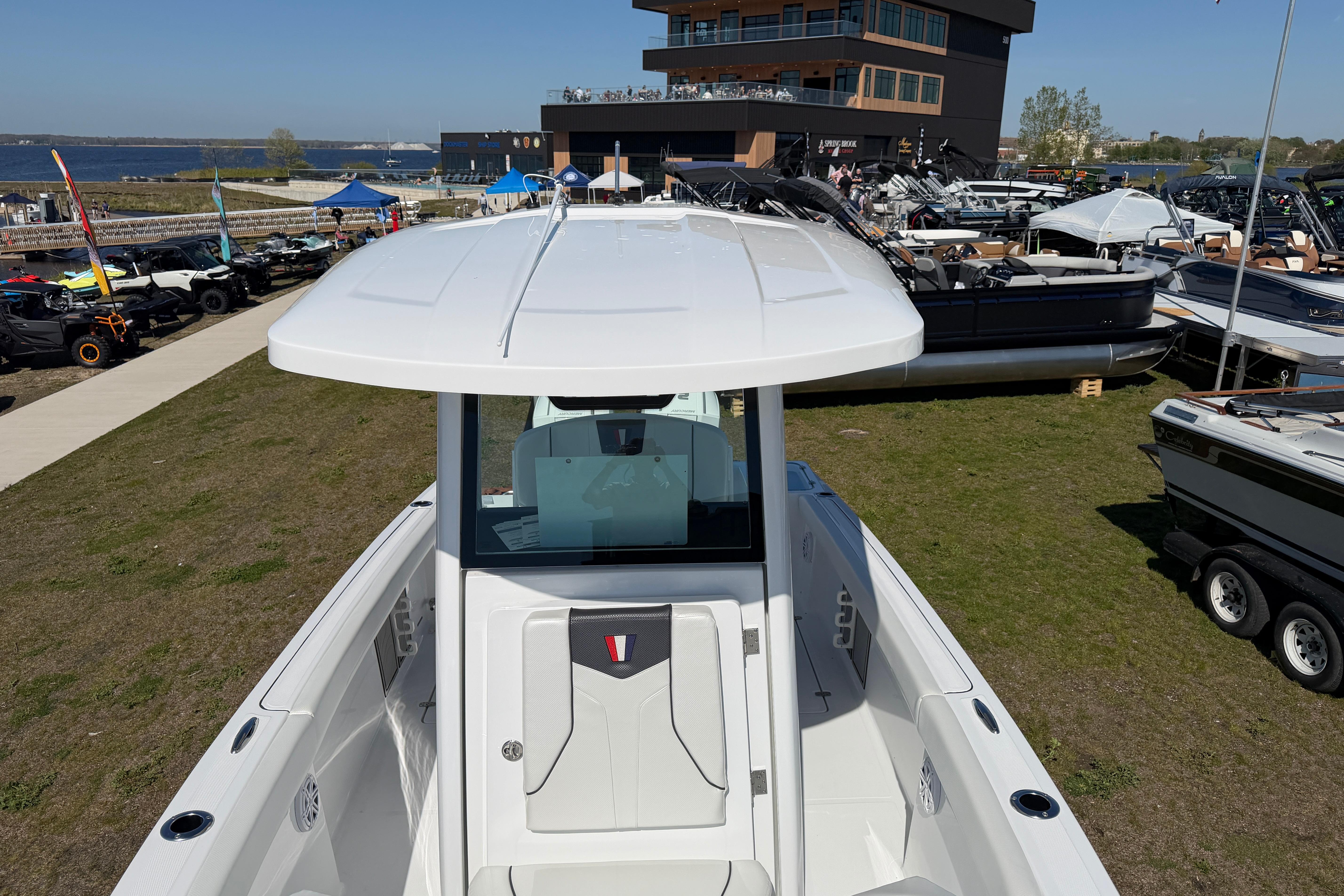 2026 Wellcraft 243 Fisherman at a boat show.