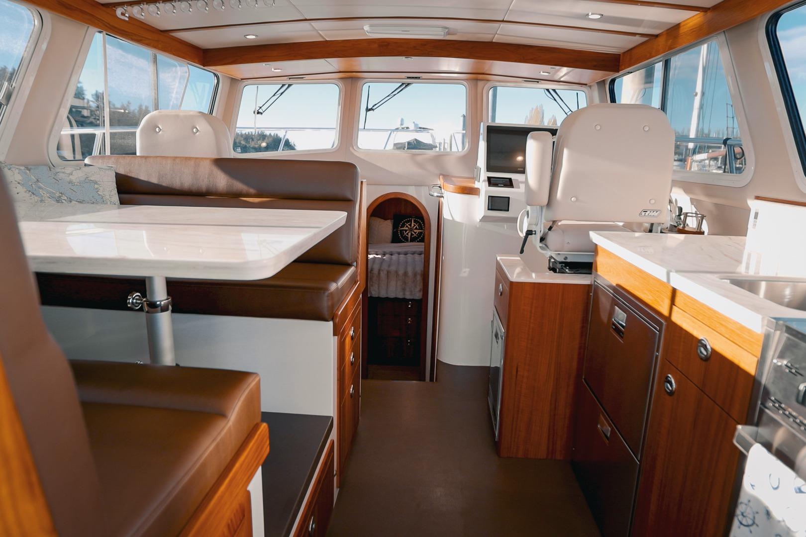 Luxurious interior of a 2027 Lindell 42' yacht featuring modern seating and elegant wood finishes.