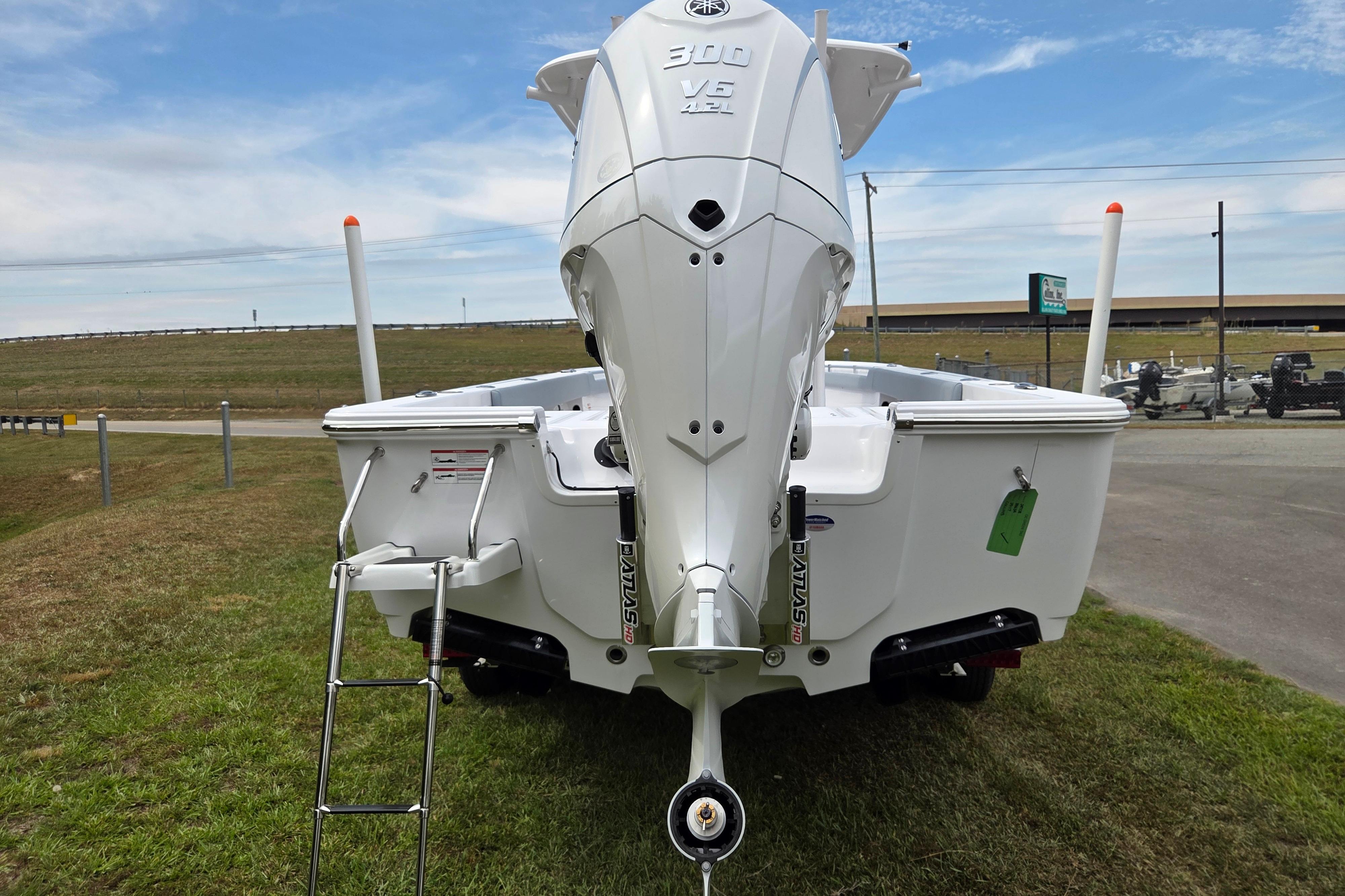2026 Sportsman Masters 247OE Bay Boat rear view with powerful outboard motor.