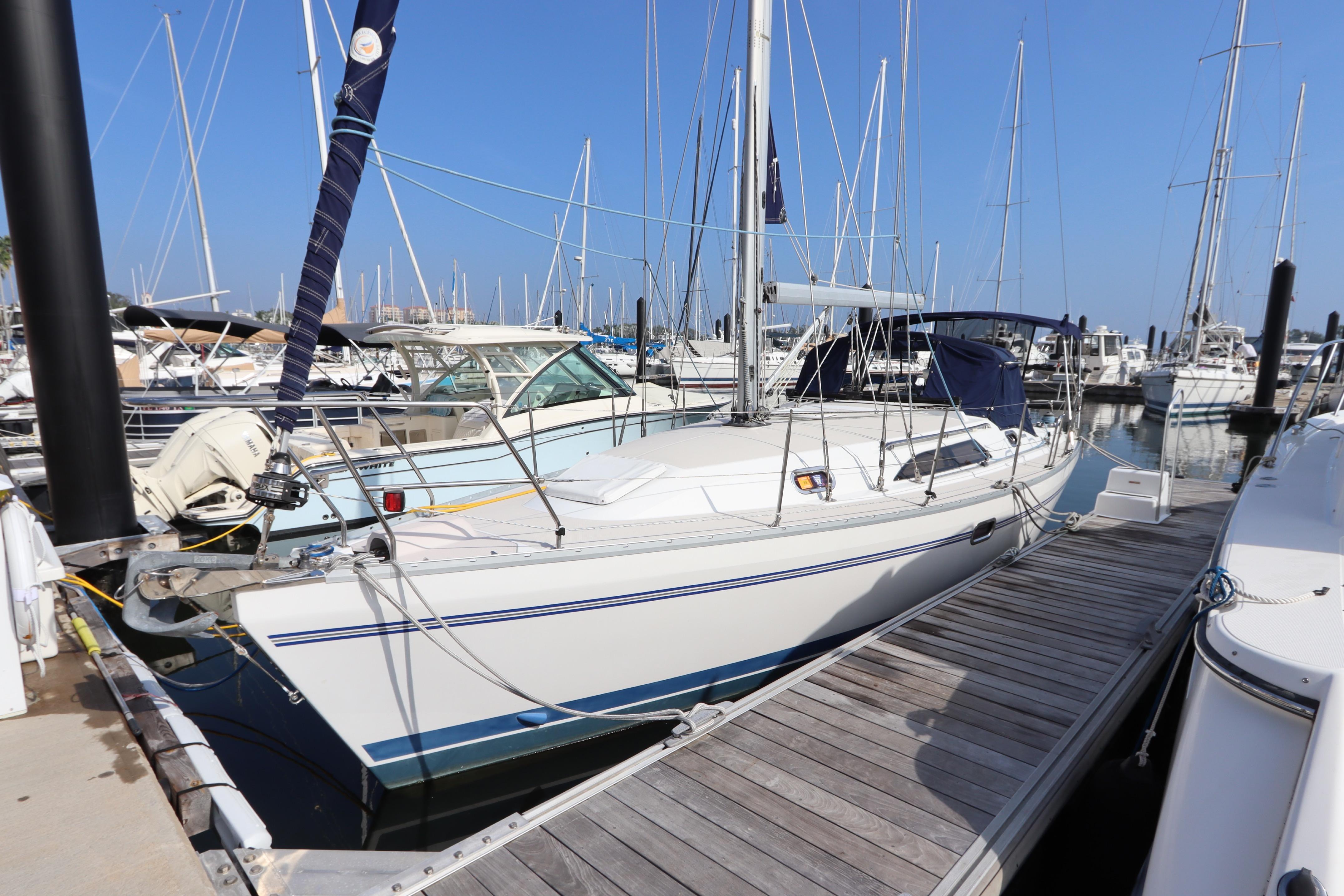 2011 Catalina 355 sailboat docked at marina with clear blue sky.