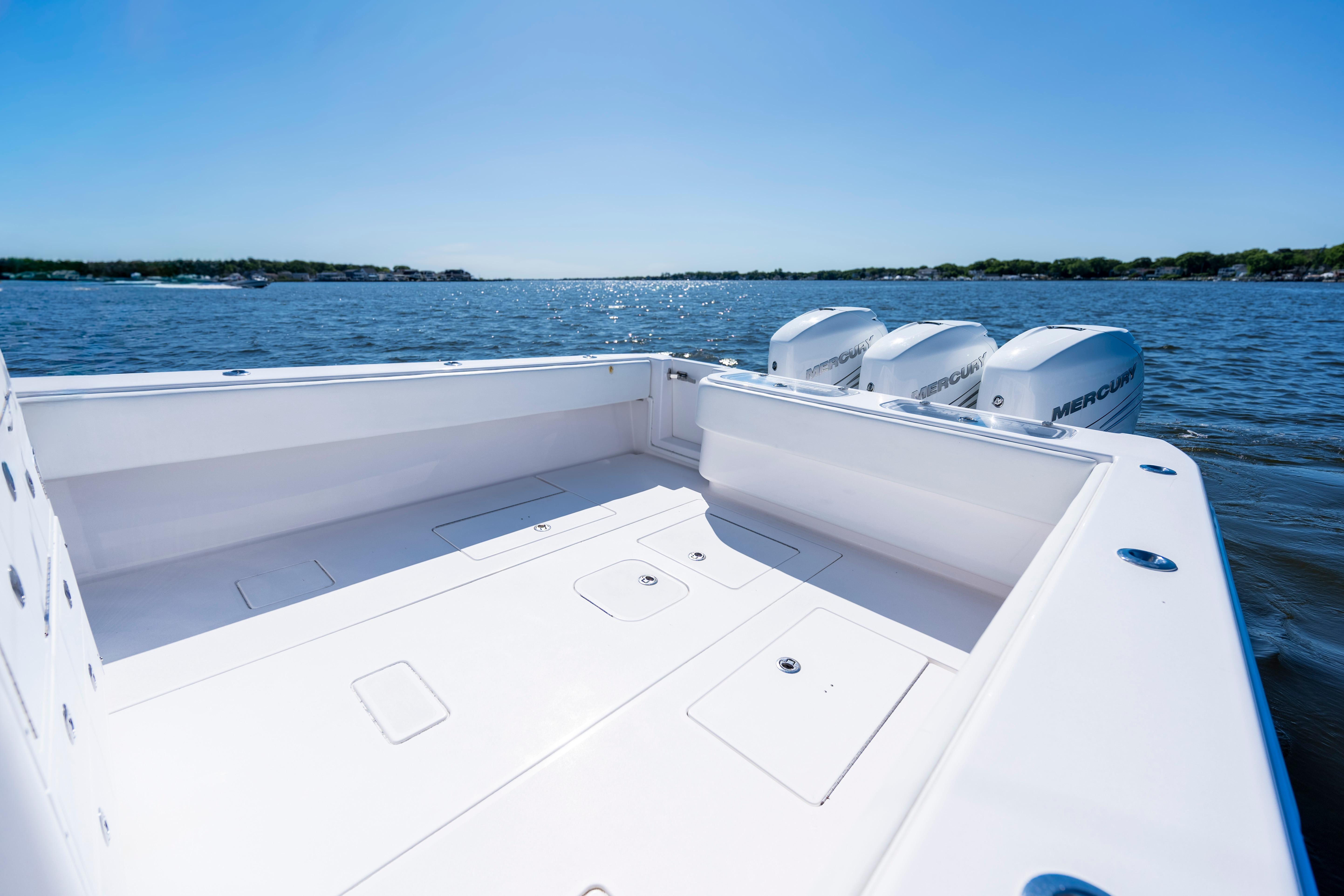 2015 Contender 39 ST boat with triple Mercury engines on open water.