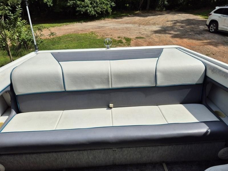 The image shows a gray and white bench seat on a boat.