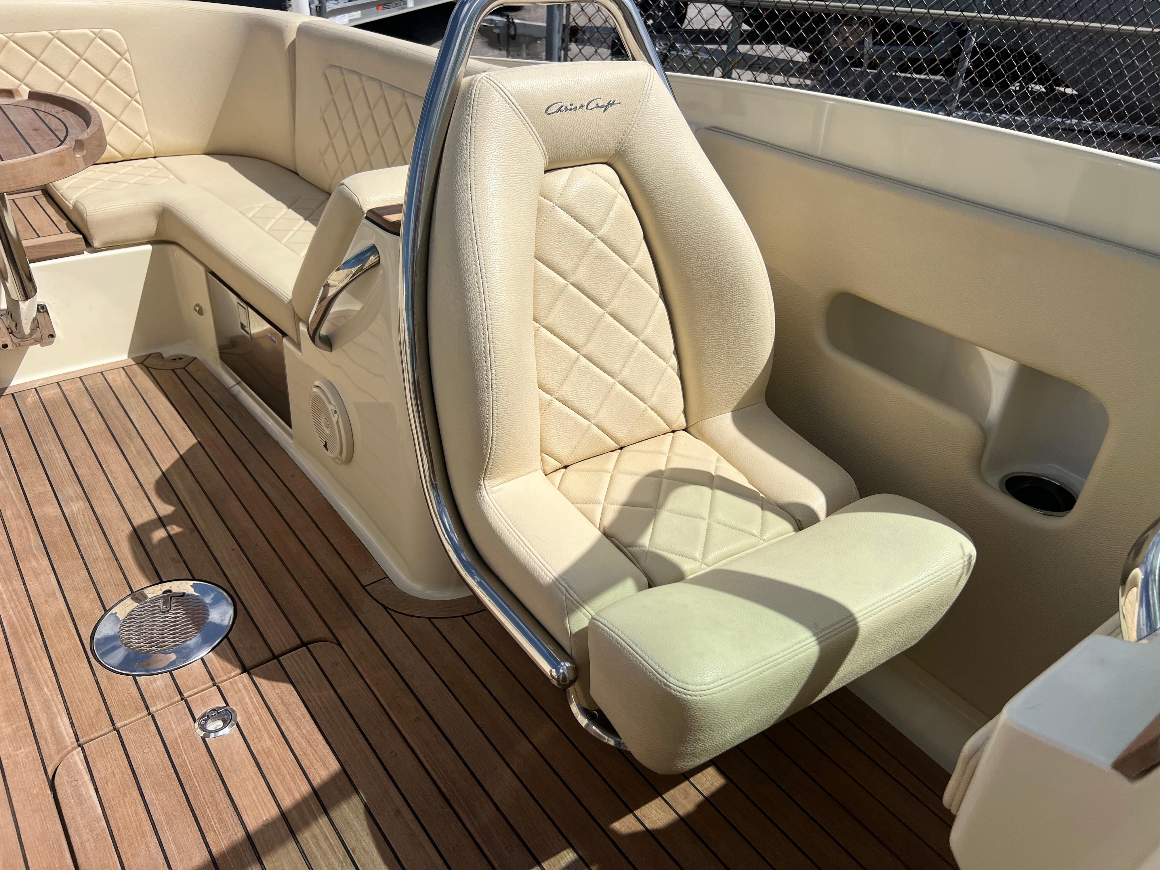 Luxurious seating on 2019 Chris-Craft Corsair 27 boat with elegant upholstery and teak flooring.