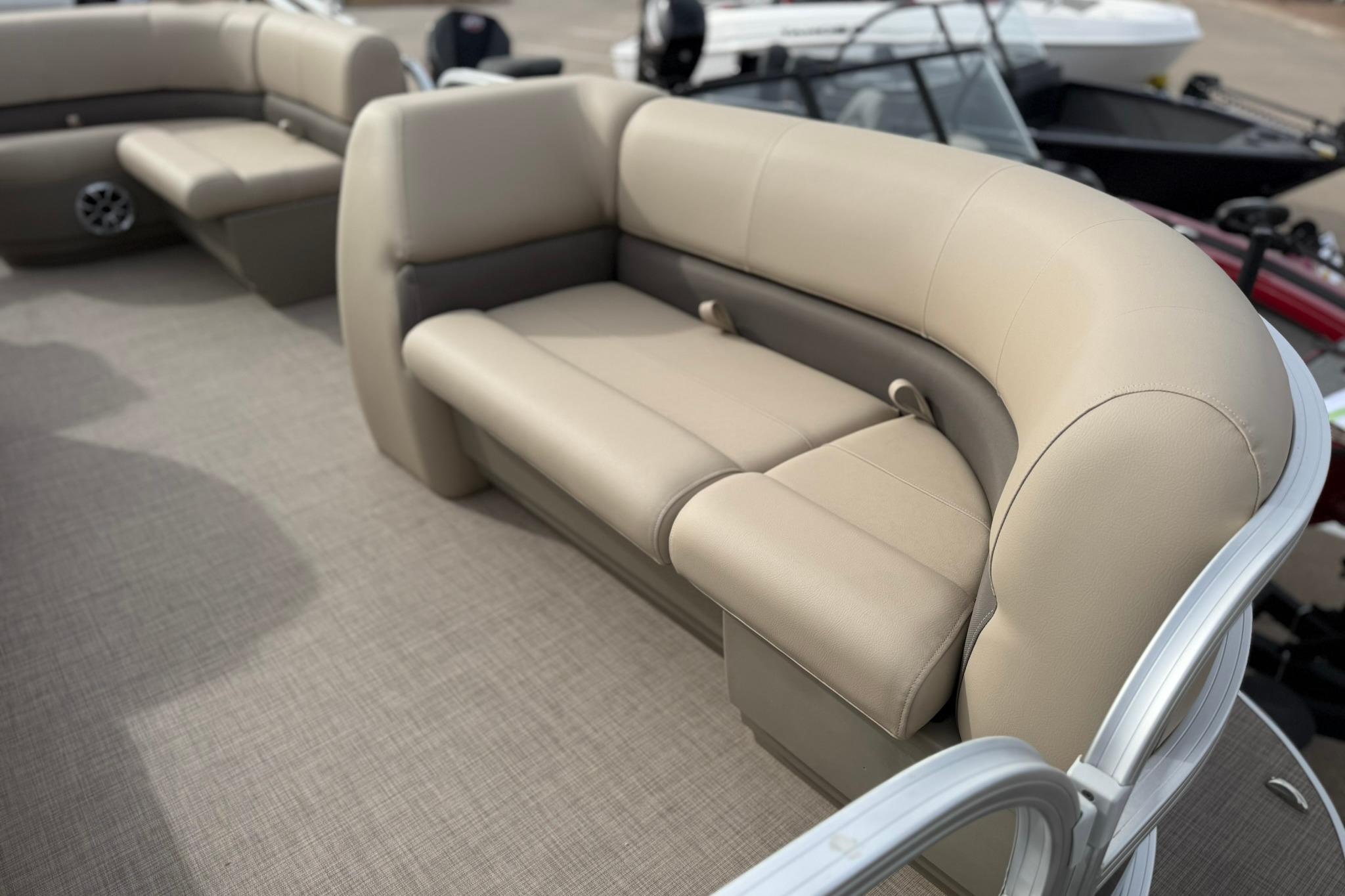 2025 Sun Tracker Party Barge 18 DLX pontoon boat with beige seating and spacious layout.