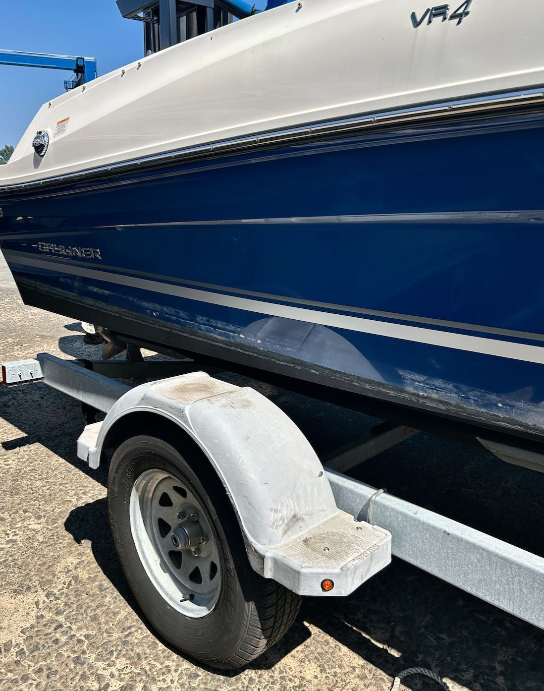 A blue and white 2019 Bayliner VR4 Bowrider OB on a trailer.
